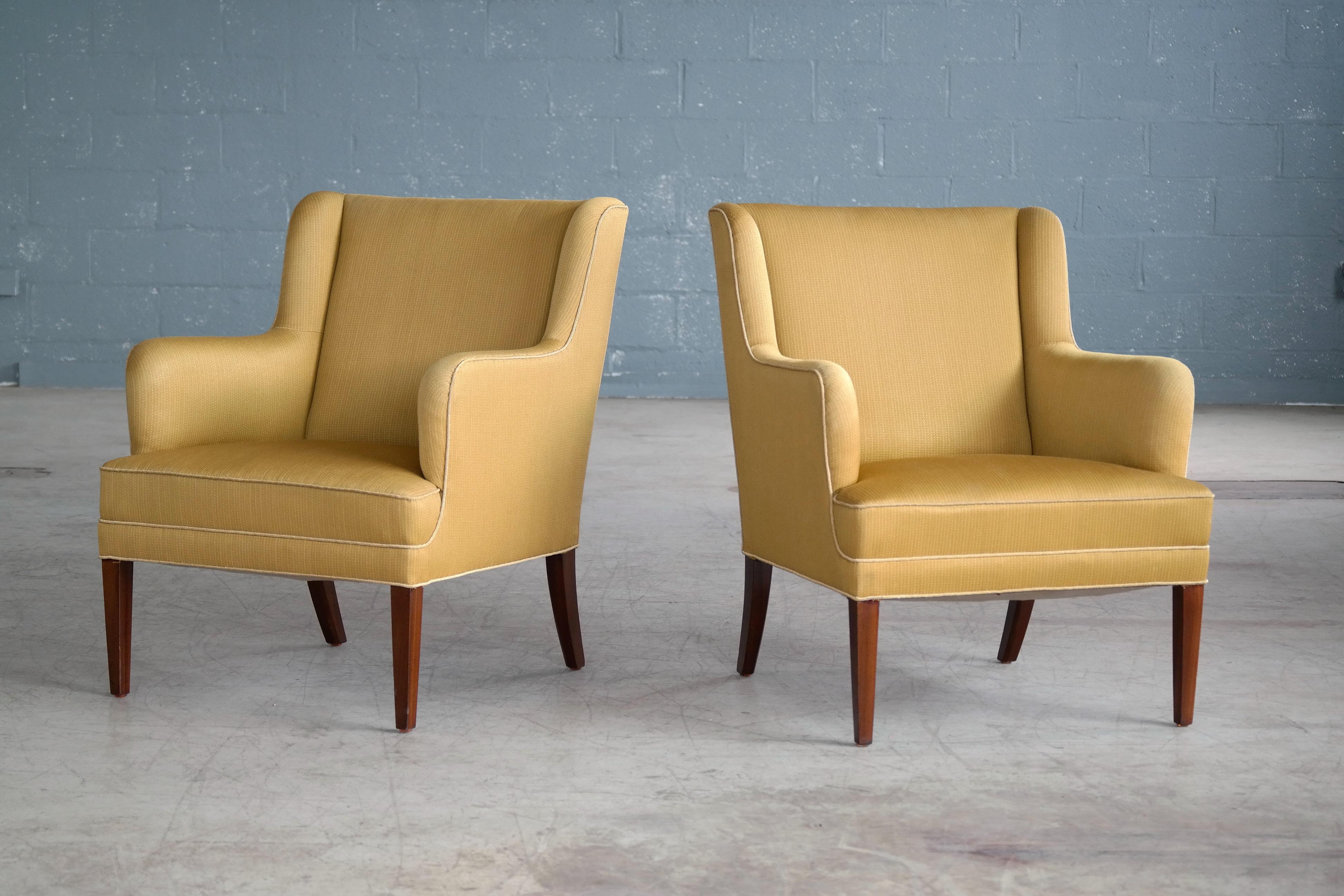 Classic Frits Henningsen lounge chairs made in Denmark circa 1950. Frits Henningsen's elegant and modern style go equally well in very modern environments or with something more traditional which is a main reason they are so sought after. These