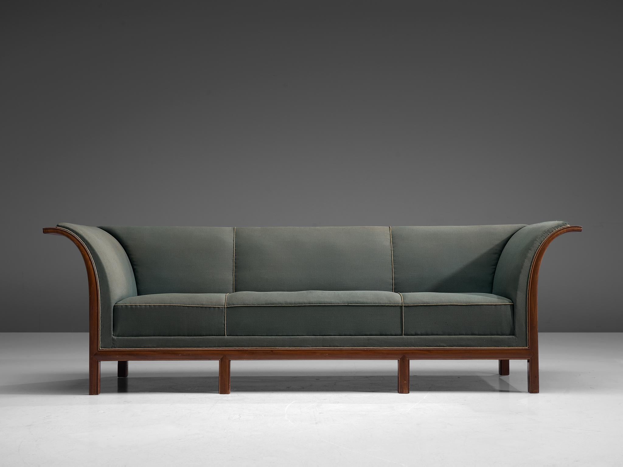 Frits Henningsen, sofa in mahogany and green fabric, Denmark, 1930s.

This classic sofa was designed and produced by master cabinet maker Frits Henningsen around the 1930s. The basic design is well balanced, showing an interesting contrast between