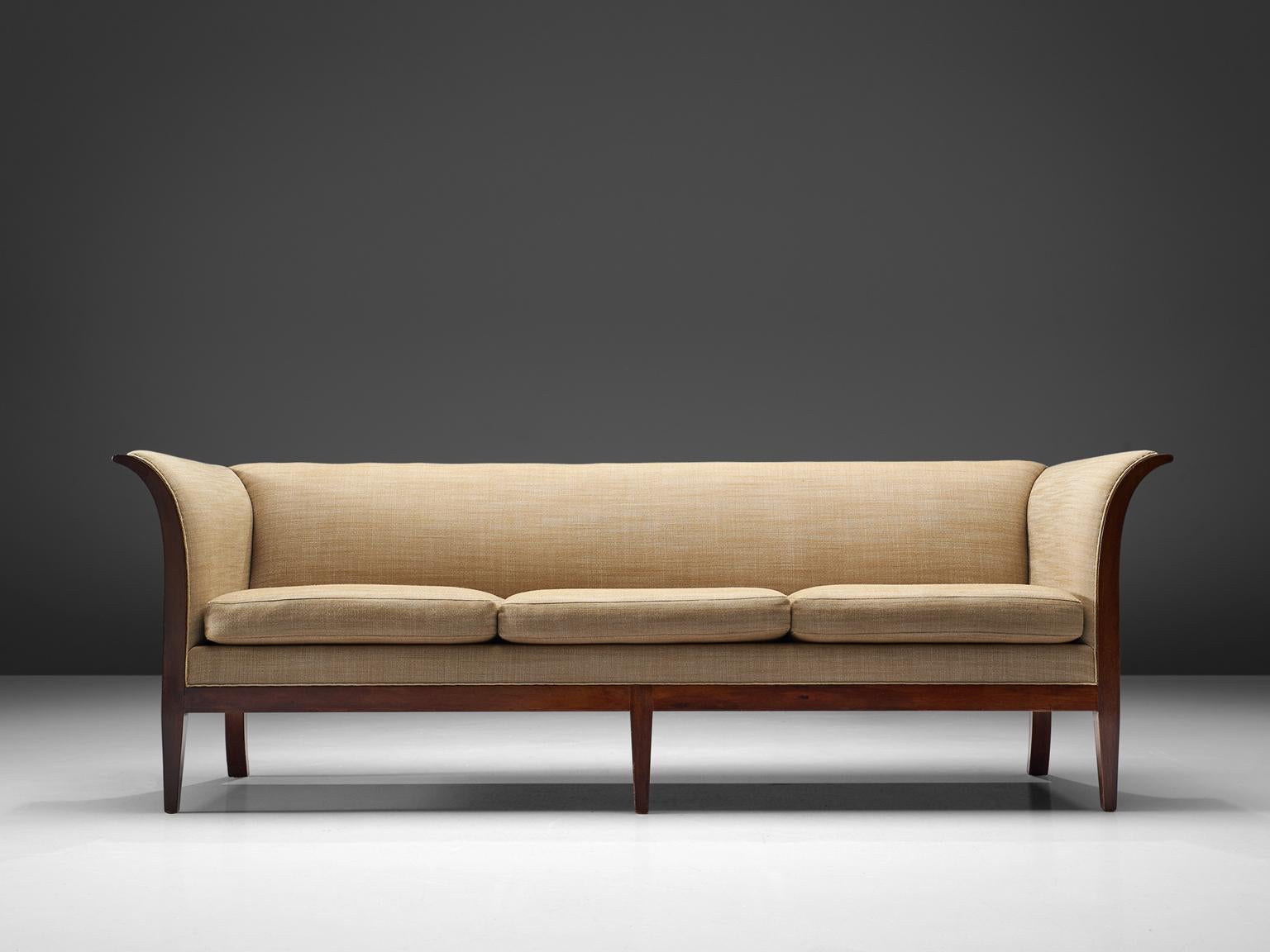 Frits Henningsen, sofa in mahogany and beige to green fabric, Denmark, 1930s.

This Classic sofa was designed and produced by master cabinet maker Frits Henningsen around the 1930s. The basic design is well balanced, showing an interesting contrast
