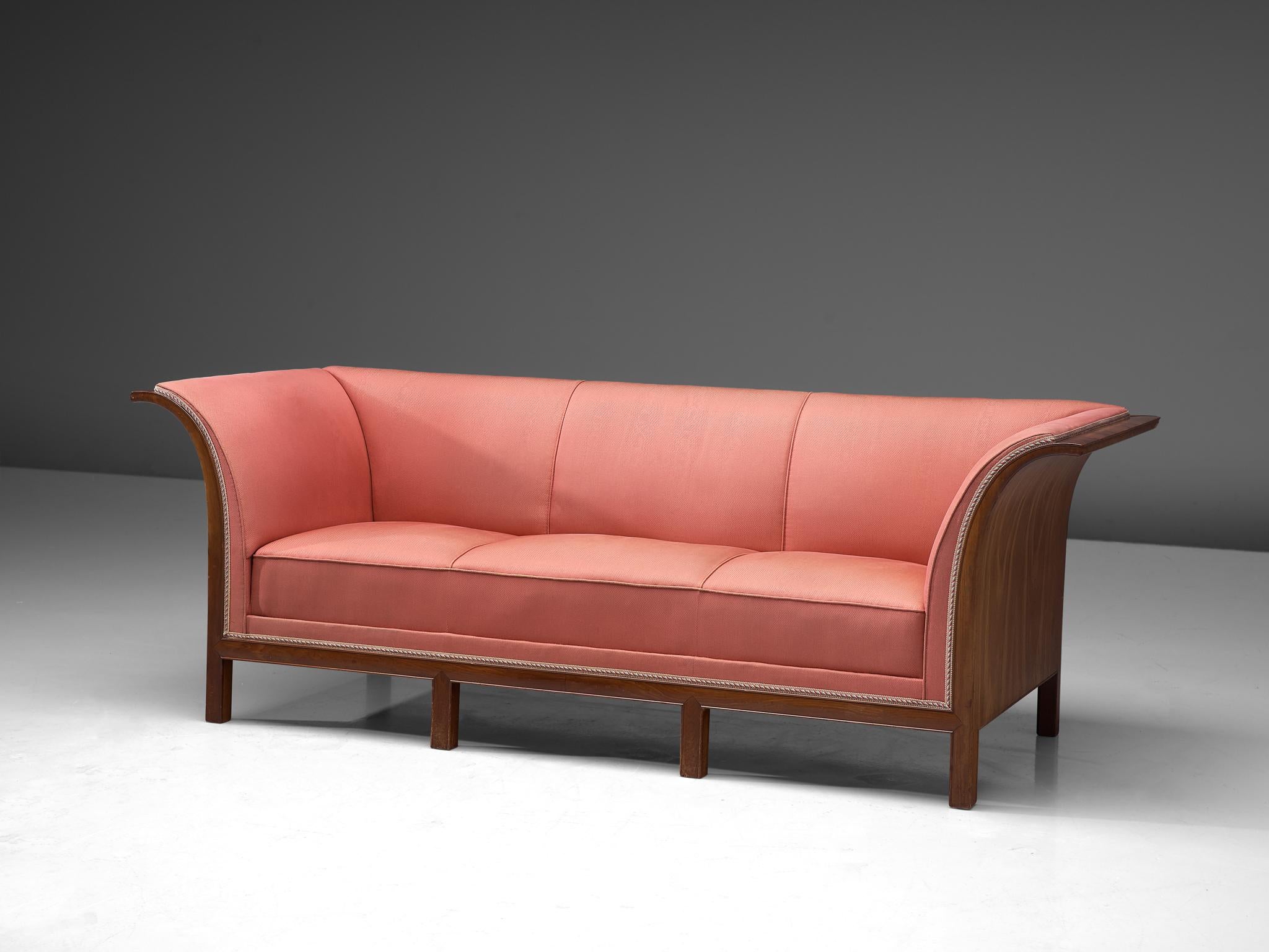 Frits Henningsen, sofa, mahogany, pink fabric, Denmark, 1930s

This classic sofa was designed and produced by master cabinet maker Frits Henningsen around the 1930s. The basic design is well-balanced, showing an interesting contrast between the