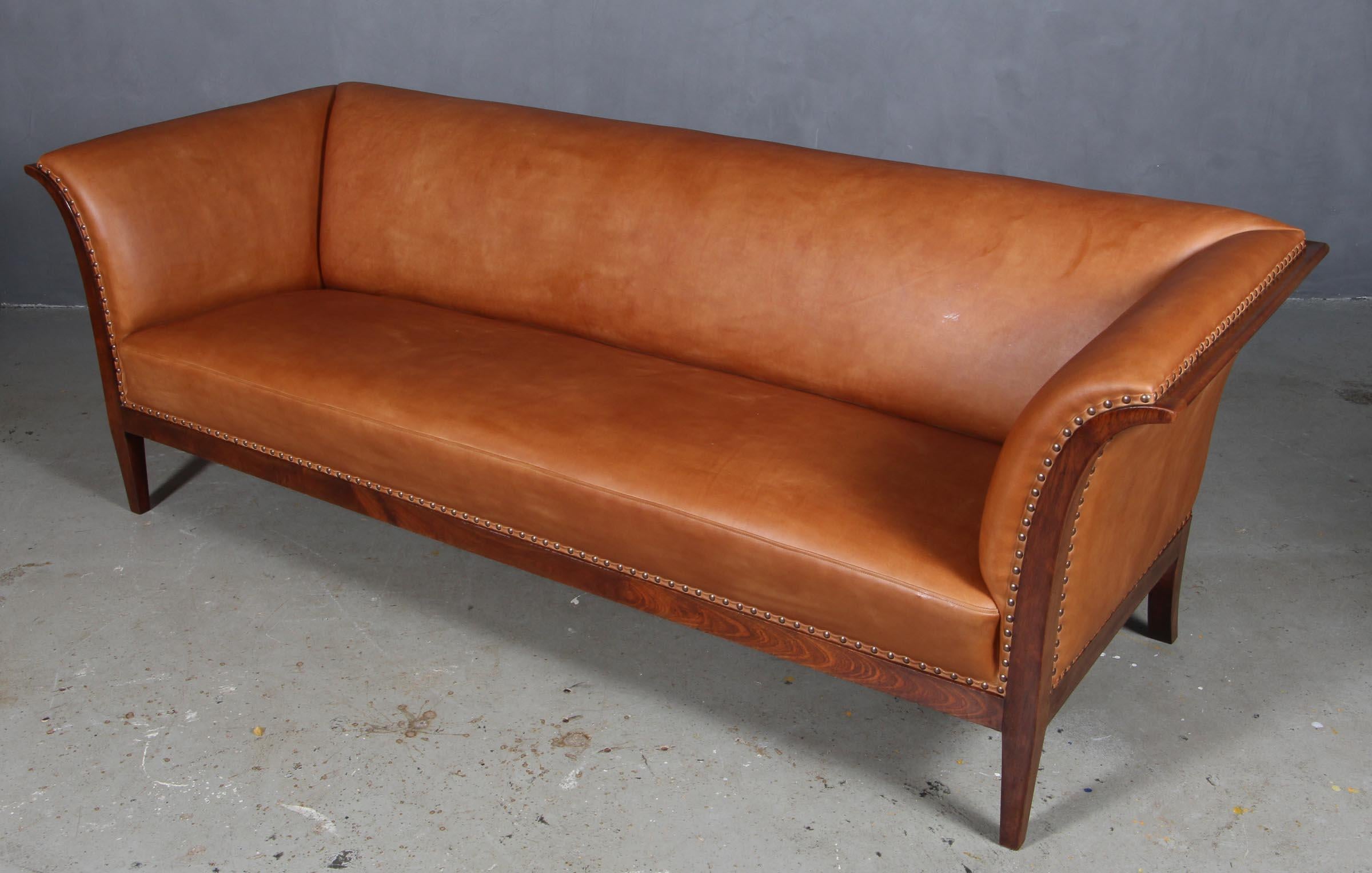 Frits Henningsen three seat sofa new upholstered with cognac vintage aniline leather.

Frame of mahogany. 

Made in the 1940s. New spring base.

 