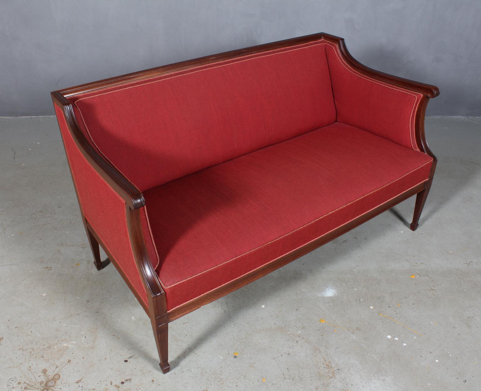 Frits Henningsen two-seat sofa in mahogany.

Upholstered with red wool.

Designed in the 1930s, made by Frits Henningsen.
     