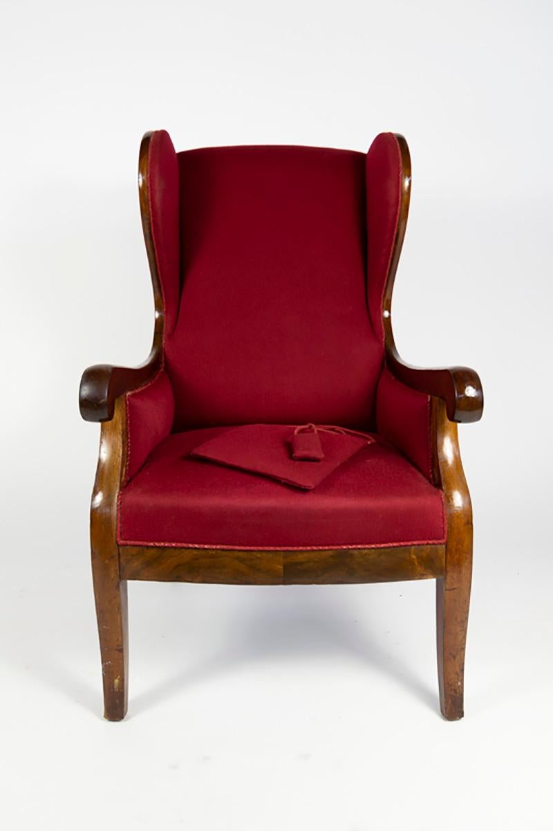 Wingback chair designed and made by Frits Henningsen with frame of mahogany. Seat, arms and back upholstered with original red fabric. Comes with the original small nek pillow with weight to keep it in its place. Small sign of use on piping around