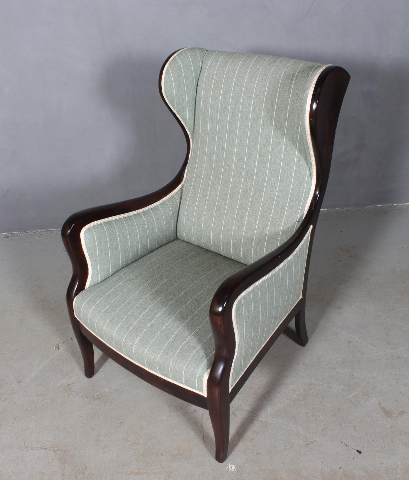 Frits Henningsen wingback chair. Frame of mahogany

Newly upholstered with striped upholstery.

Designed in the 1930s, made by Frits Henningsen.
 