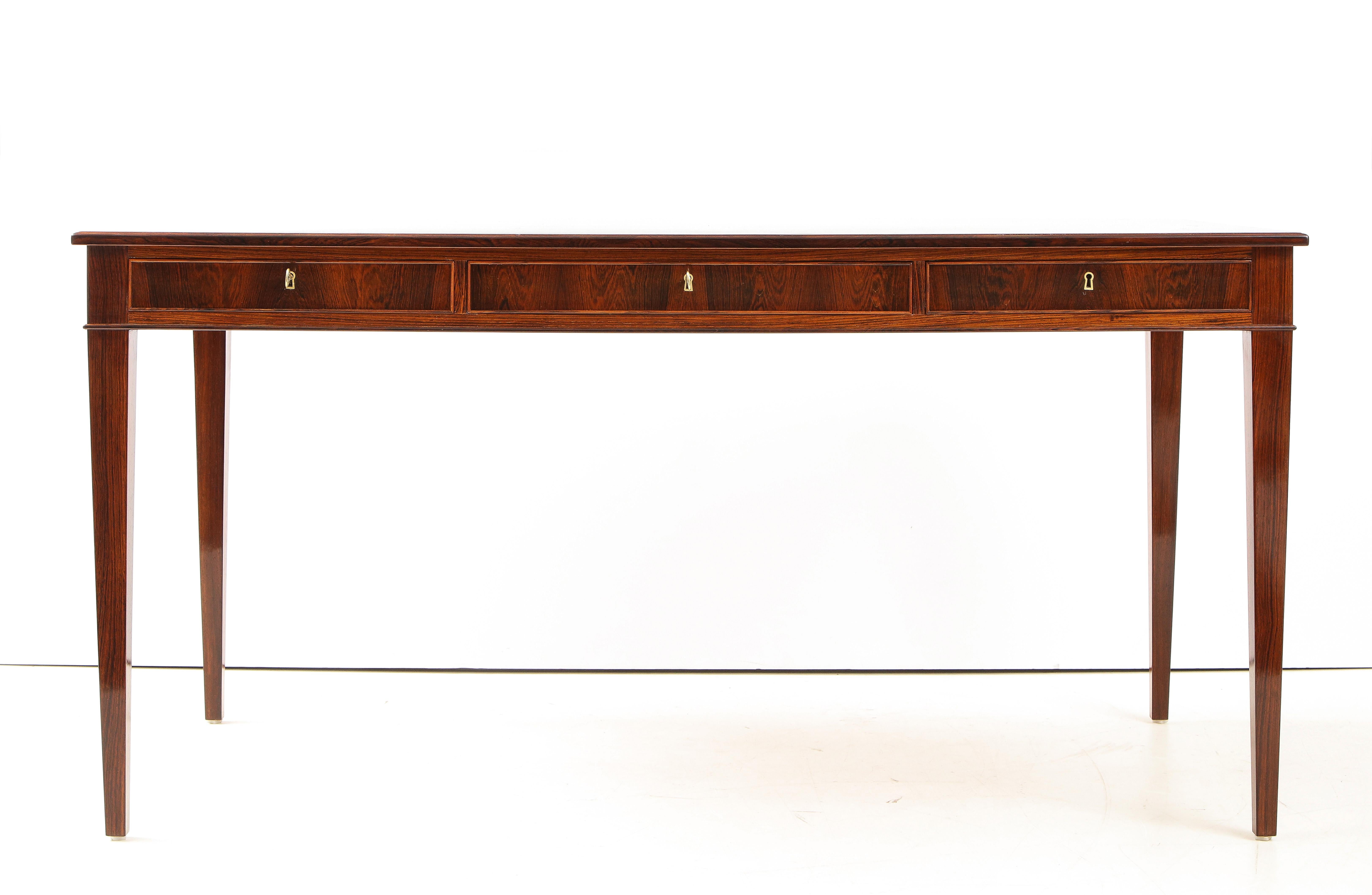 A Danish rosewood writing desk by Frits Henningsen, furniture designer and cabinet maker, (1889-1965). This desk is a Classic example of Henningsen's elegant clean lines and use of quality woods with perfect balanced craftsmanship. Designed in 1933.