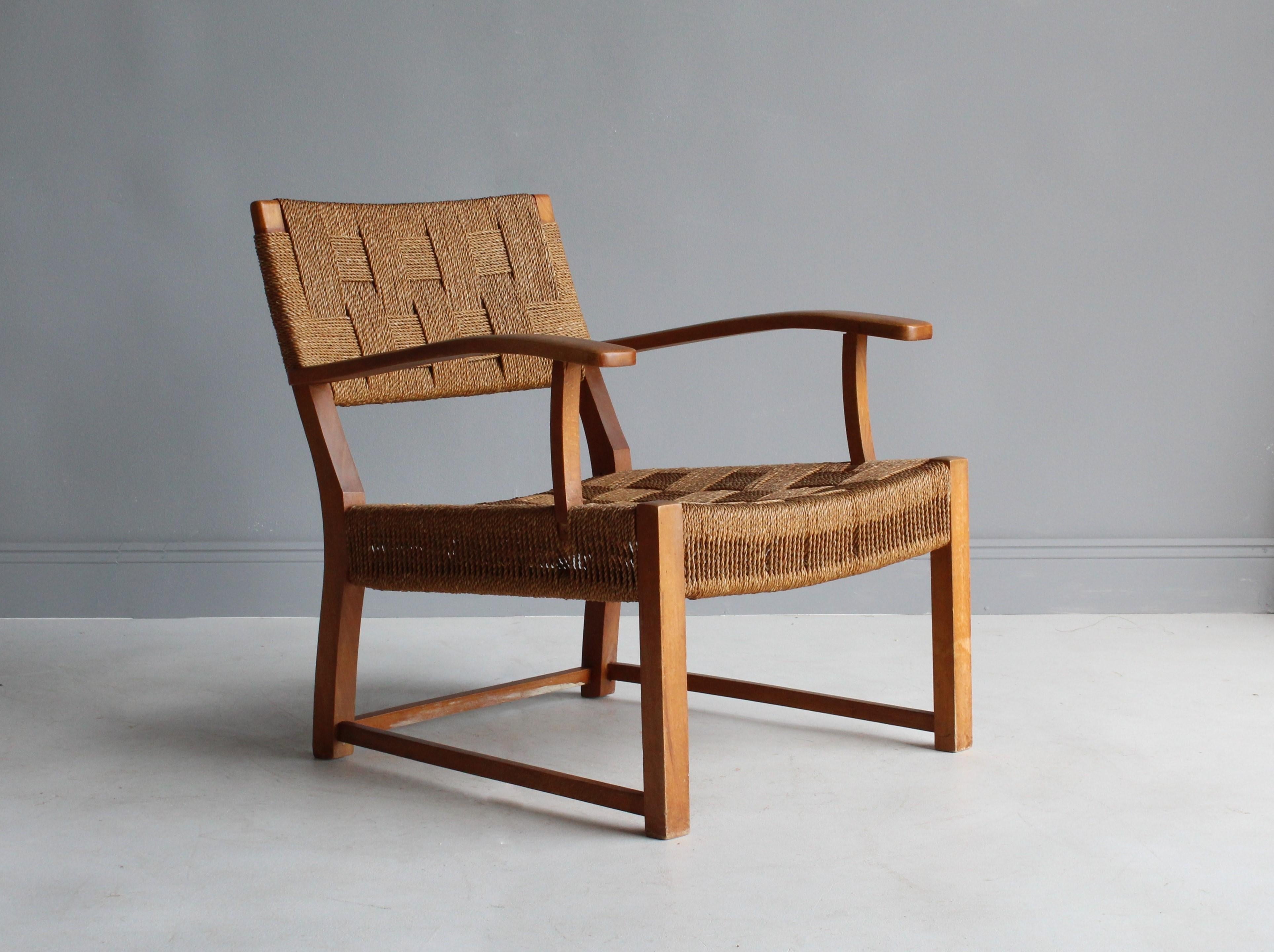 A modernist lounge chair or armchair attributed to Danish architect and designer, Frits Schlegel. Frame made of stained birch, bears original seagrass cord.

Other Nordic designers of the period include Kaare Klint, Edvard Kindt-Larsen, Vilhelm