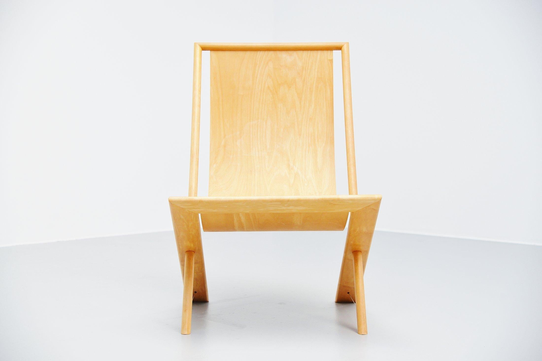 Very nice lounge chair designed and made by Frits Swart, Holland, 1979. Frits swart was a poet and craftsman. This chair has an amazing construction where a thin flexible plywood seat is fixed between the frame. The legs are supported by a metal