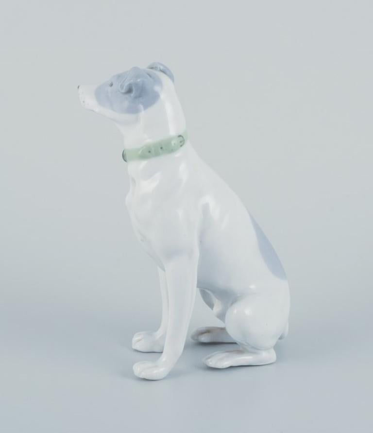 Fritz and Ilse Pfeffer, Gotha, Germany. 
Porcelain figurine of a seated dog. 
The figurine was produced between the years 1900 and 1934.
In beautiful condition with a firing flaw on the back.
Stamped GP
Dimensions: Length 7.5 cm x Height 14.0 cm.