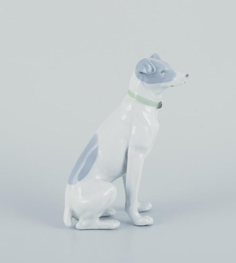 Glazed Fritz and Ilse Pfeffer, Gotha, Germany. Porcelain figurine of a seated dog. For Sale