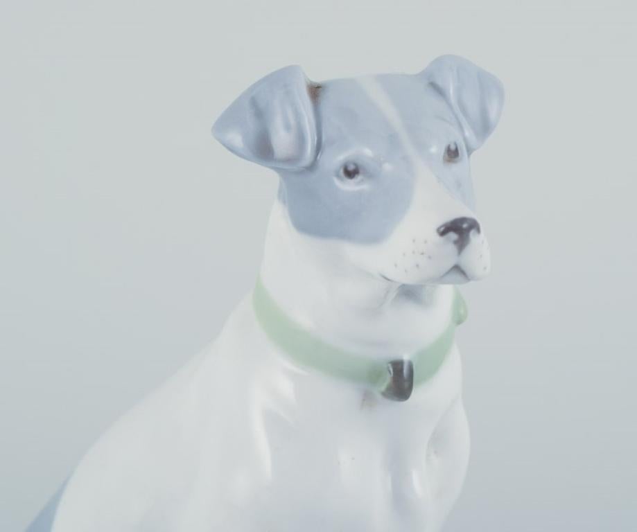 Fritz and Ilse Pfeffer, Gotha, Germany. Porcelain figurine of a seated dog. In Good Condition For Sale In Copenhagen, DK