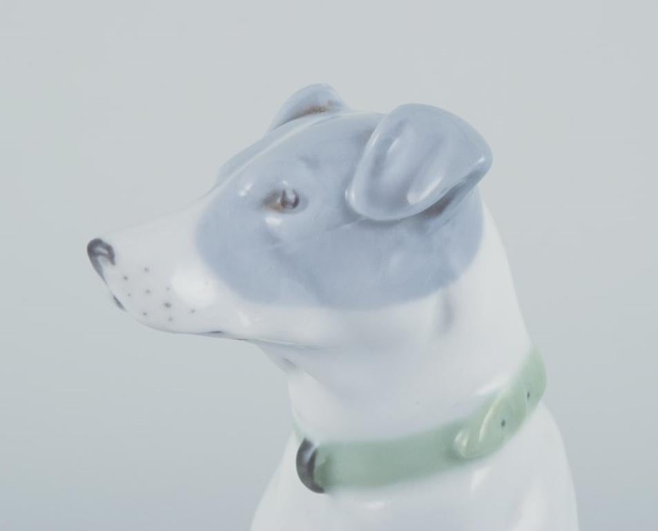 20th Century Fritz and Ilse Pfeffer, Gotha, Germany. Porcelain figurine of a seated dog. For Sale