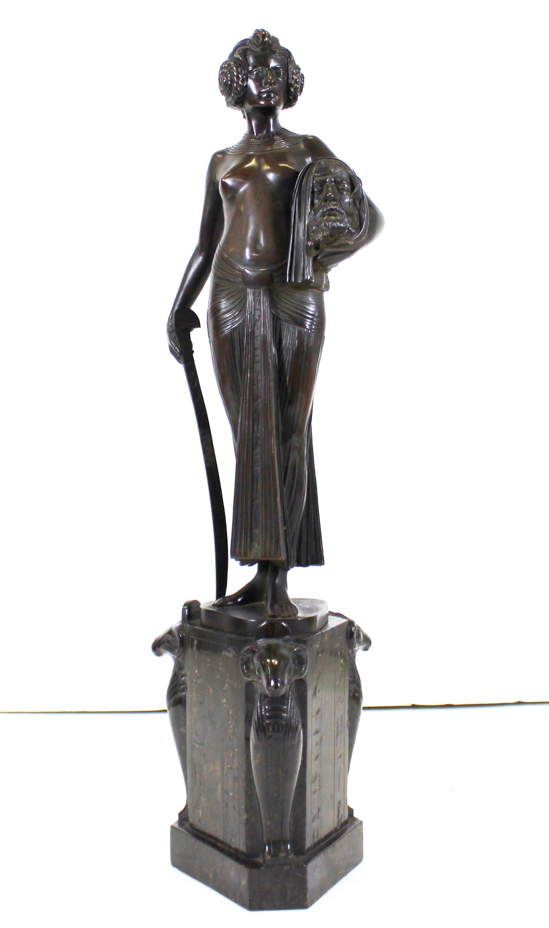 German Jugendstil bronze sculpture of Judith holding her sword and the head of Holofernes, made by German sculptor and medallist Frist Christ (1866-1906). The figure of Judith is standing on a hexagonal Egyptian revival marble base with carved