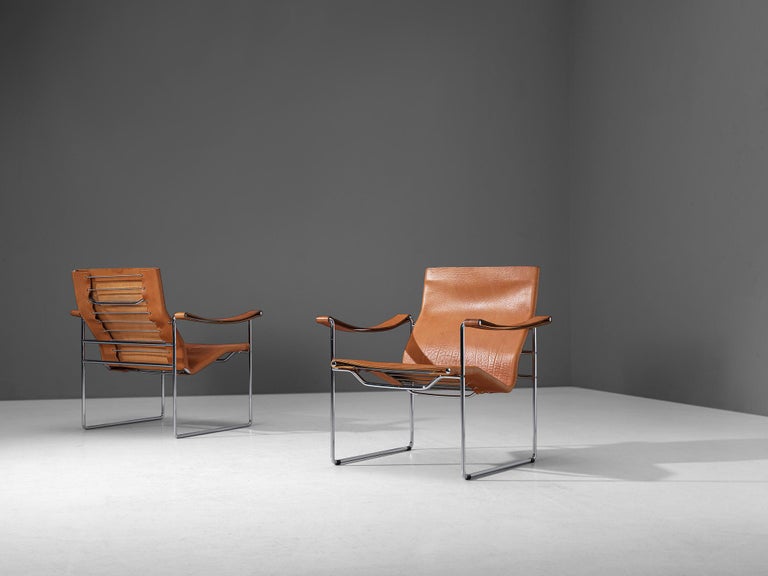 Fritz Haller for Heinrich Pfalzberger, armchairs, leather, chrome, Switzerland, late 1960s. 

Pair of elegant swiss armchairs designed by architect and furniture designer Fritz Haller (1924-2012). These chairs contain a tubular chrome frame, and