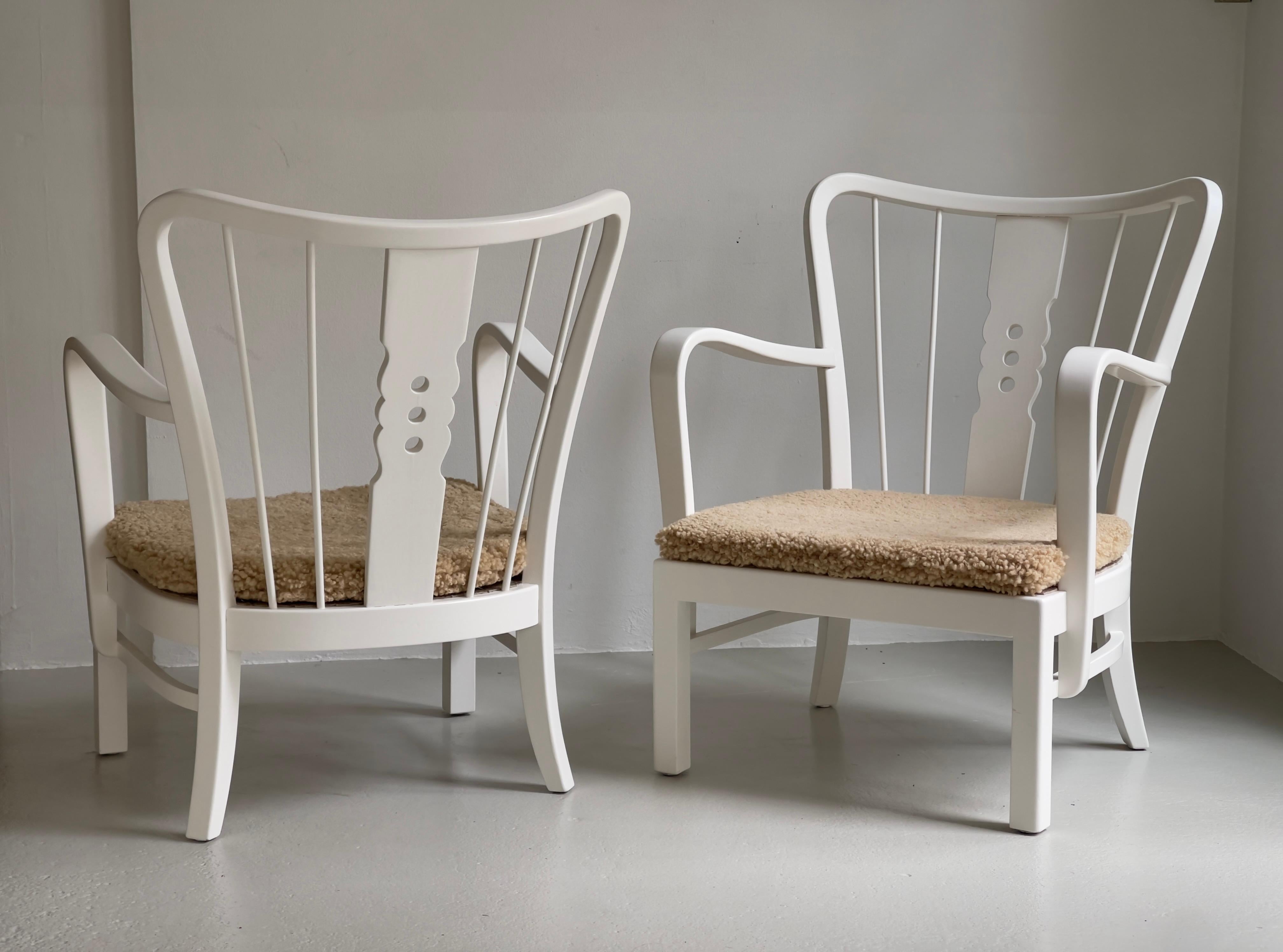 This elegant pair of Danish easy chairs, produced by Fritz Hansen in the 1930s, exemplifies the refined craftsmanship and timeless design principles of early 20th-century Scandinavian modernism. The chairs have been thoughtfully restored, featuring