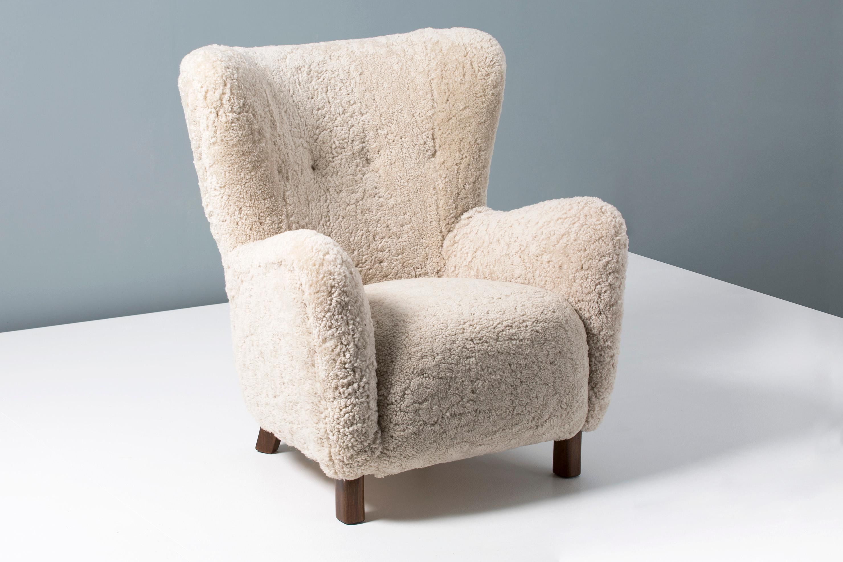 Rarely seen model 1664 lounge chair produced by Fritz Hansen in Denmark, in the 1940s-1950s. This model is similar to the iconic 1669 armchair and has a slightly higher back. The legs are stained beechwood and the chair has been completely