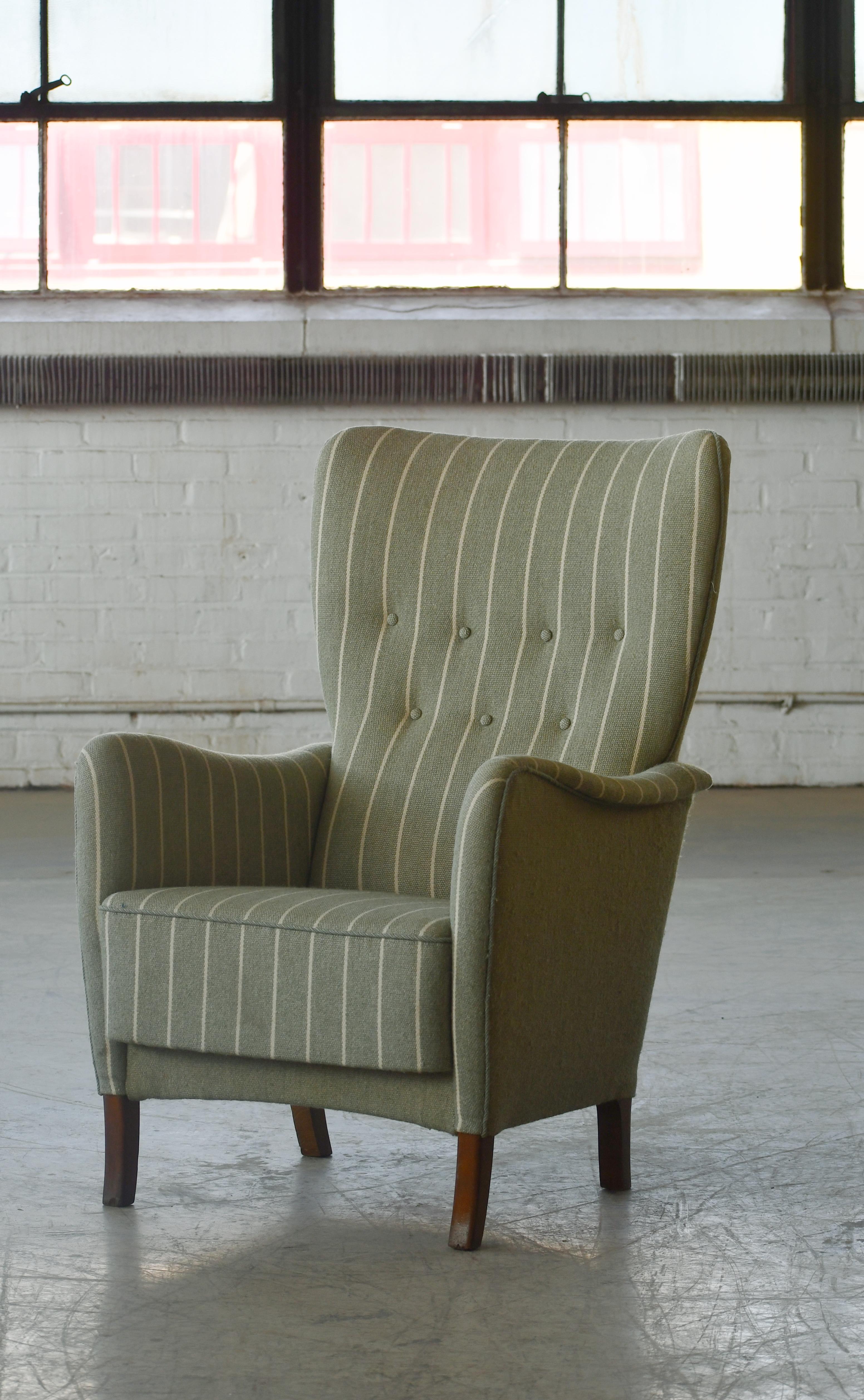 Fantastic Danish midcentury highback chair which appears to be a variant of Fritz Hansen's model 8023 from the the early 1950s. Very elegant set with a slim silhouette and a strong modern design presence. The original model 8023 had blinders or