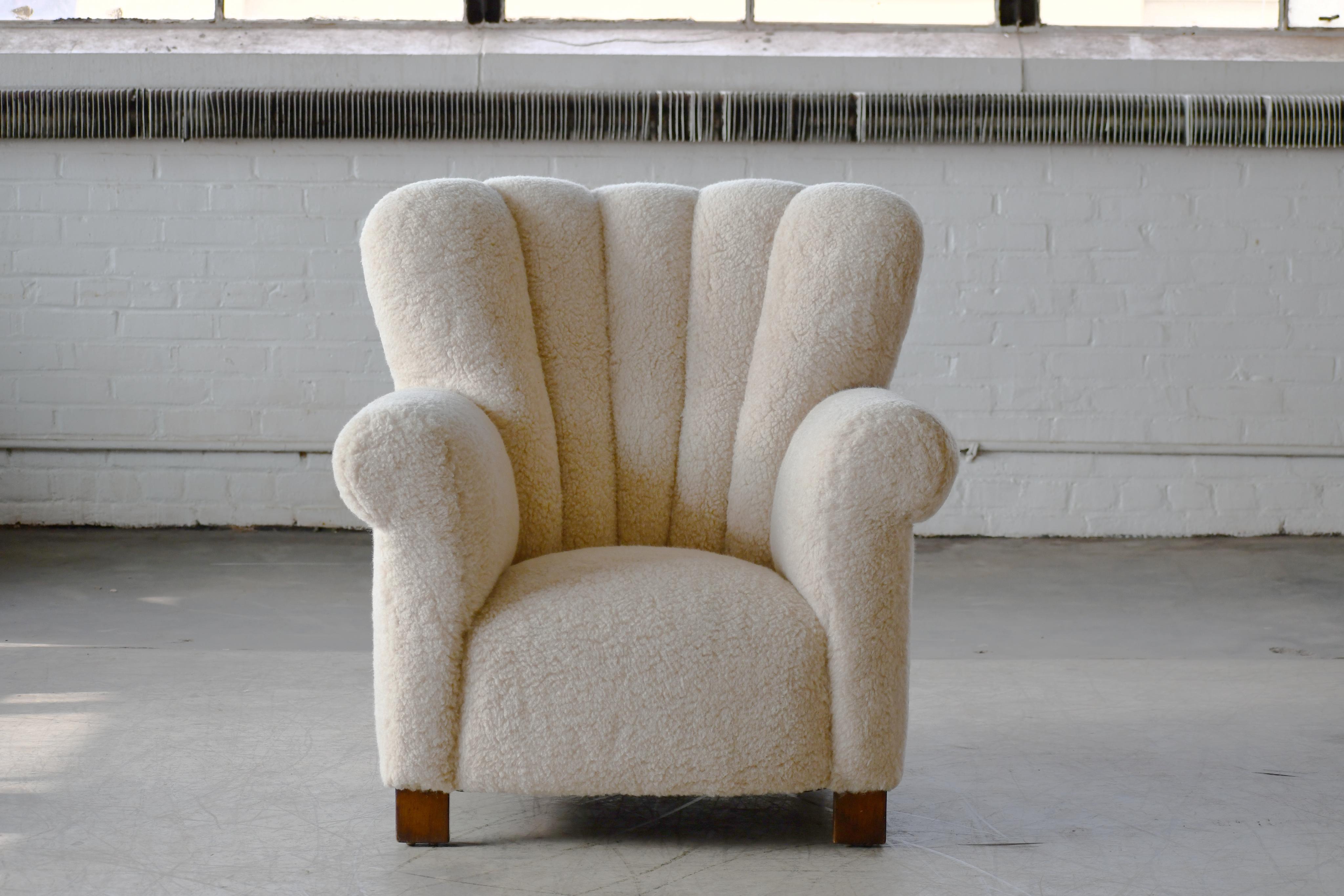 Fritz Hansen attributed 1940s Danish highback lounge chair in Lambswool.

Sublime highback lounge chair with channeled back made in Denmark in the late 1930s or early 1940s. This model chair is seen from time to time in the Danish market and is