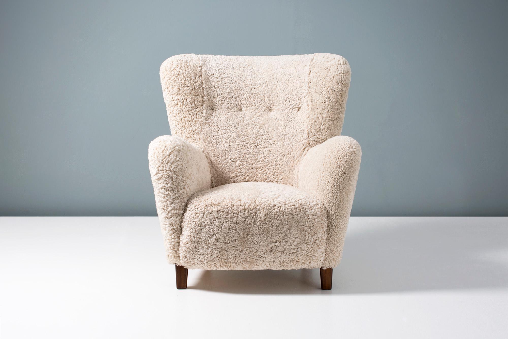 Lounge chair attributed to Fritz Hansen, produced in Denmark between 1940-1955. The legs are stained beechwood and the chair has been completely reconditioned in our London workshop with new upholstery in luxurious Australian shearling. The springs