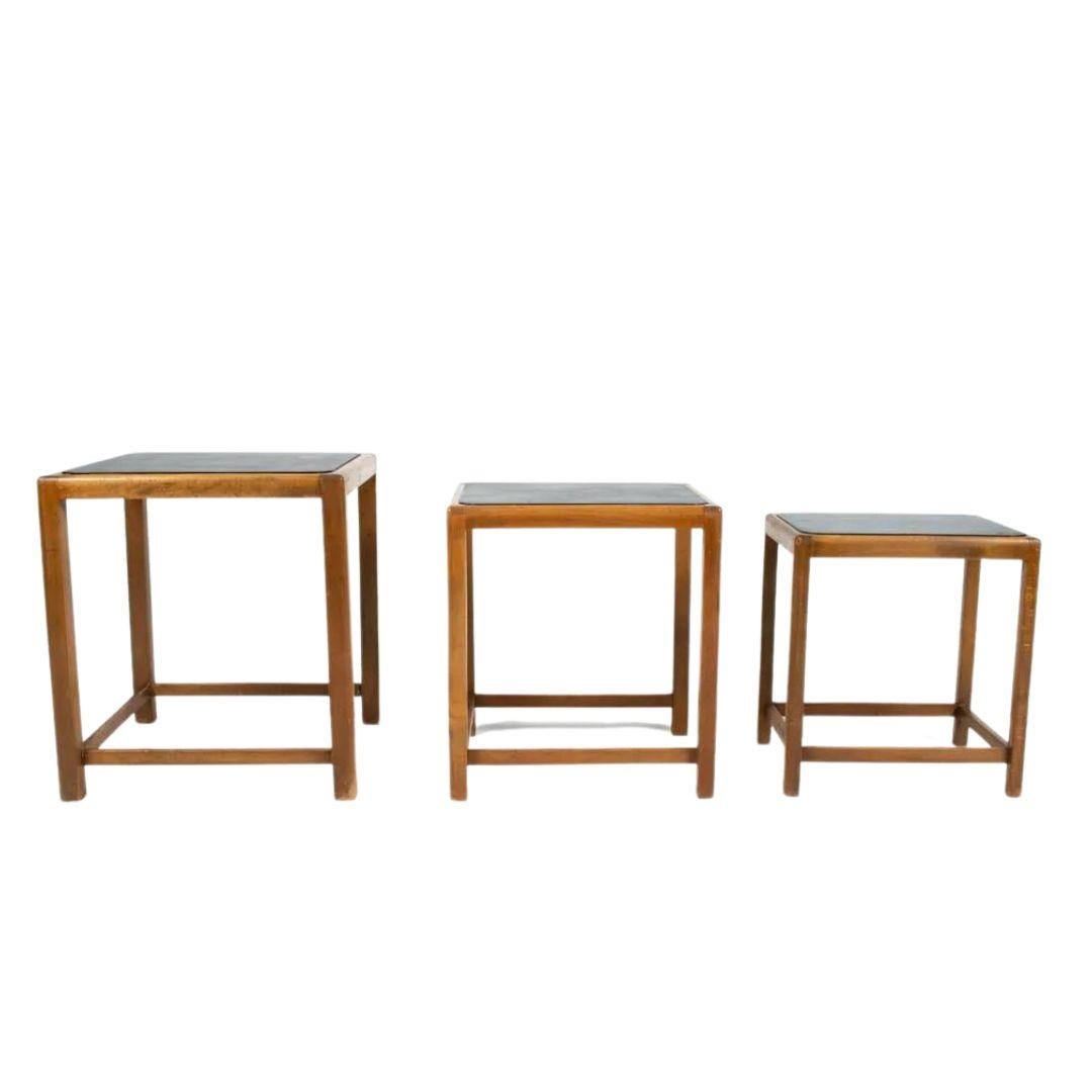 Danish Mid-Century nesting tables crafted of beech wood with black painted tops. Attributed to Fritz Hansen.

Note: Black paint may not be original. Frames with scattered dings and scuffs, a few water spots and gouges. Minor joint separation.