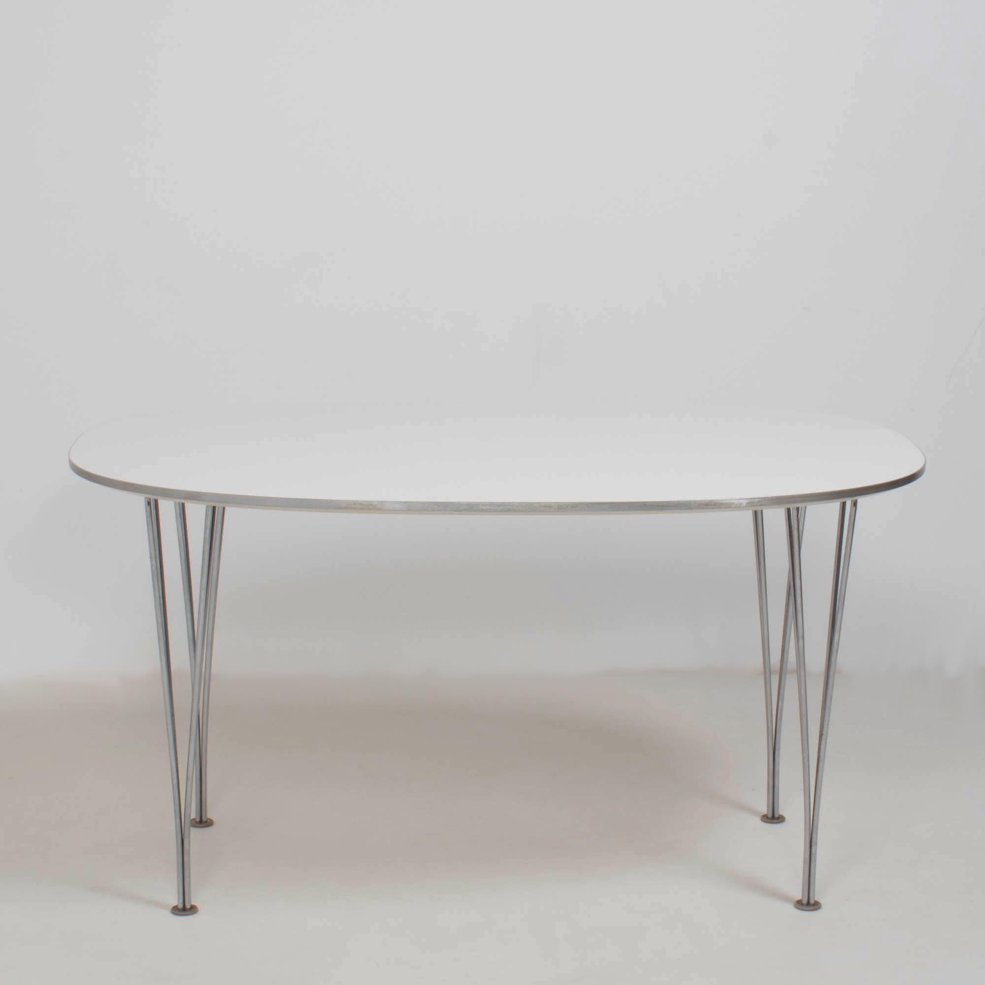 Originally designed by Piet Hein and Bruno Mathsson in 1966, this Super-Ellipitic table remains a contemporary piece of design.

Constructed with a white wood veneer top, the table sits on chromed steel legs and features rounded corners to create