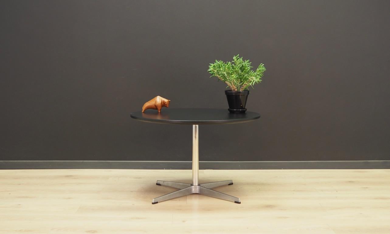 The original table from the 1960s-1970s, designed by Arne Jacobsen, produced in the company Fritz Hansen, a Minimalist form. Top covered with black paint, post made of aluminum, foot base made of chromed metal. Preserved in good condition (small