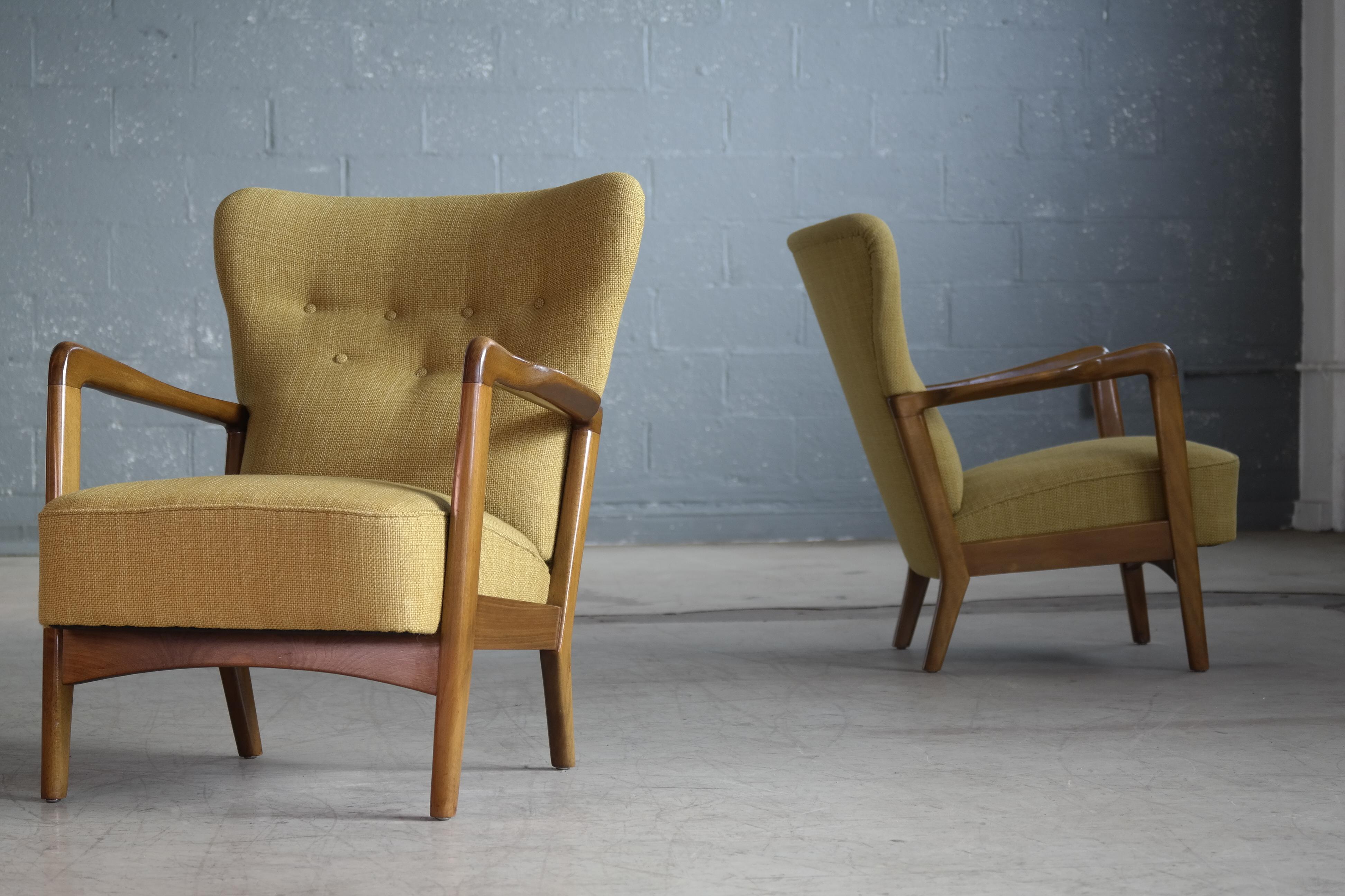 Very stylish open armchairs designed by Soren Hansen for Fritz Hansen in the early 1940s. Mainly made with high backs this set is has lower backrests adding a very cool relaxed and more modern feel to the design. Armrests made of stained and