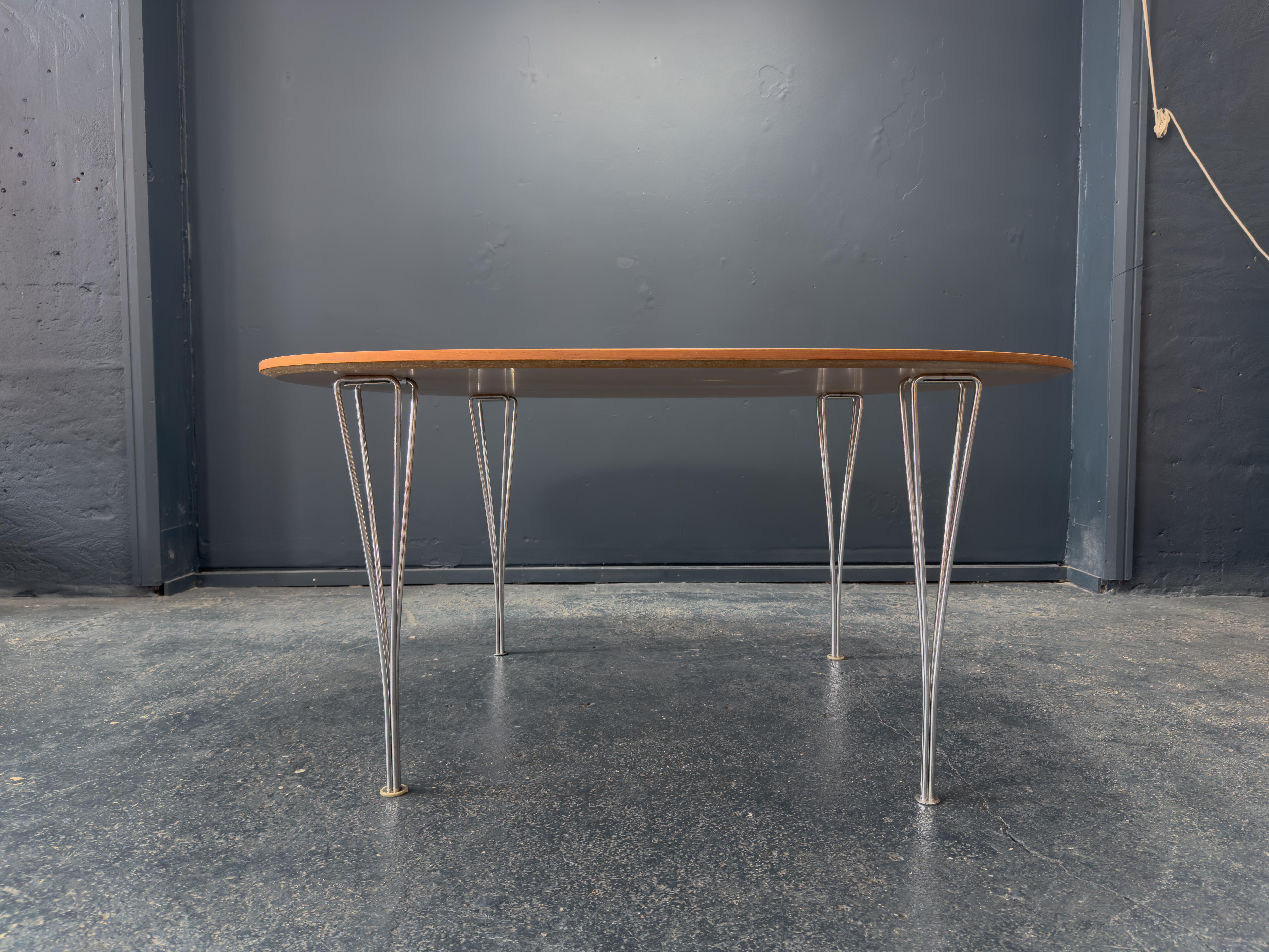 This striking dining table by Fritz Hansen exemplifies the Danish design house’s commitment to elegant minimalism and impeccable craftsmanship. Featuring a rich teak top with soft, elliptical edges, the table offers a beautifully warm and organic