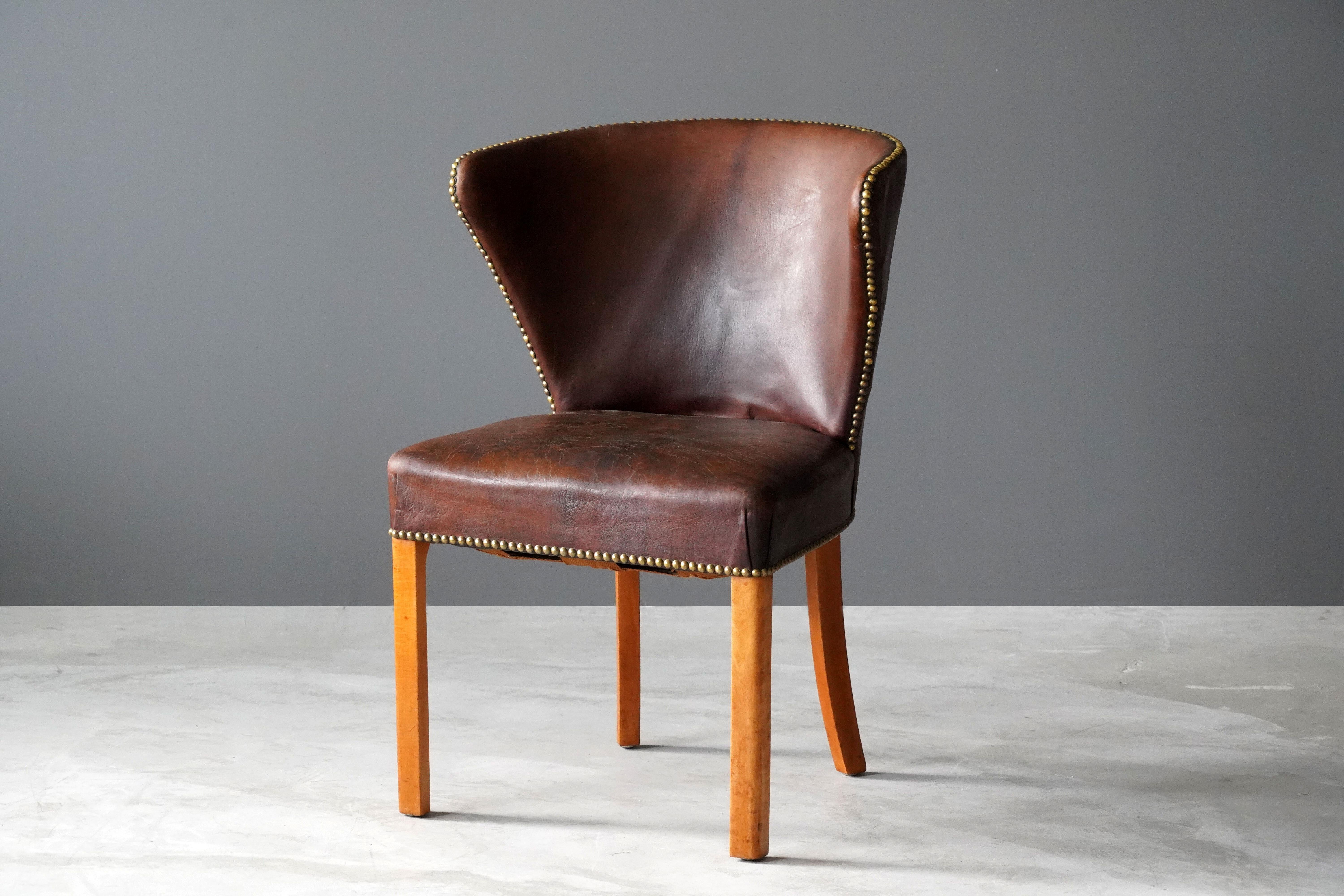 An early all original side chair. Designed and produced by Fritz Hansen. In original leather and brass nails. 

Other designers of the period include Kaare Klint, Frits Henningsen, Ole Wanscher, and Arne Jacobsen.