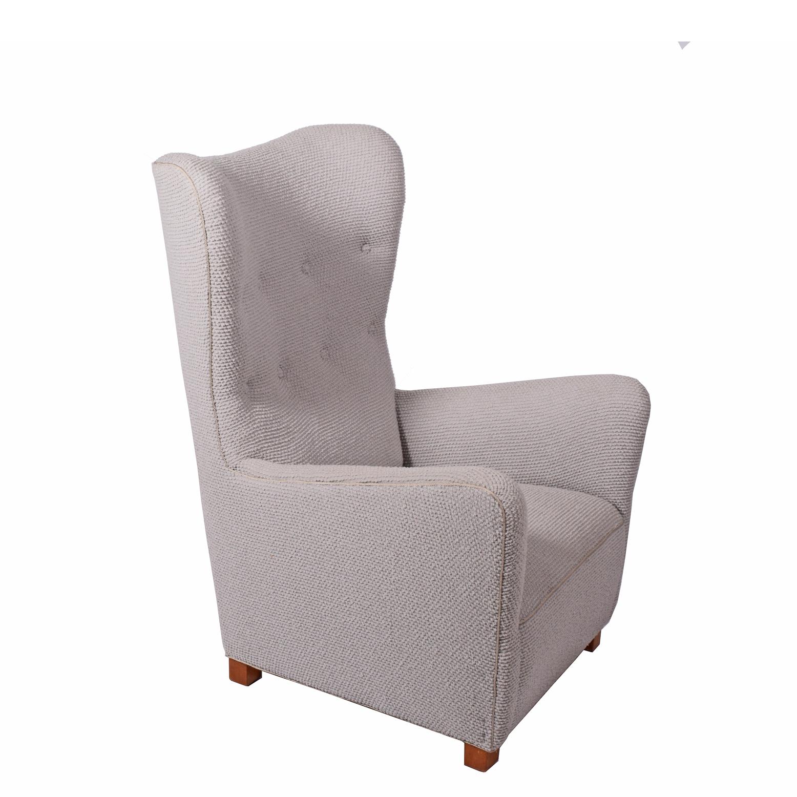 Free-form high back wing chair with large curved arms on original beechwood legs. Reupholstered in designer fabric. Made by Fritz Hansen in 1942. Catalog, page 12.