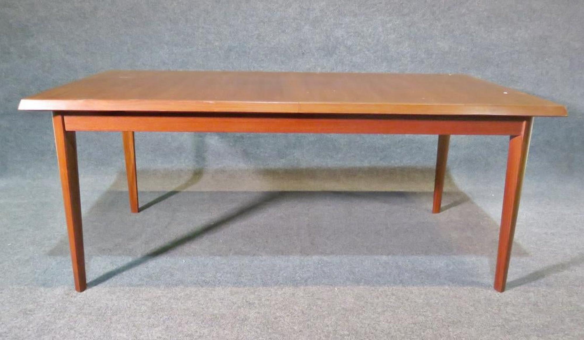 Mid-Century Modern teak table with built in leaves. Pop up leaves measure: 21.5