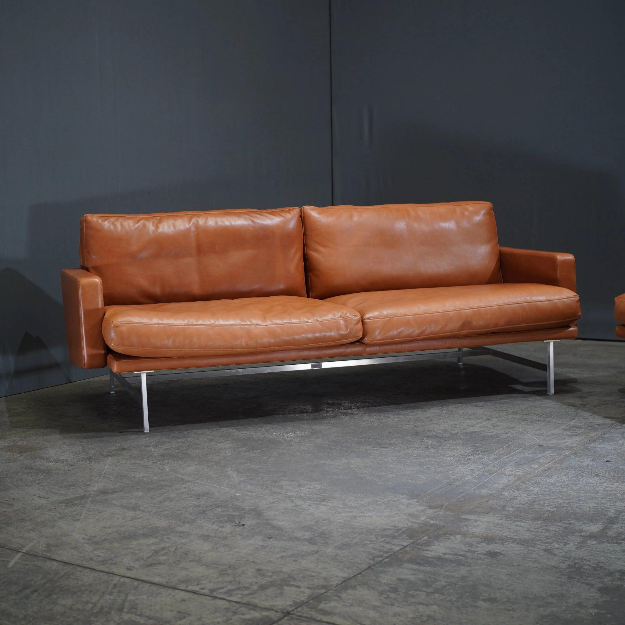 The Fritz Hansen Lissoni Two Seater Leather Sofa by Piero Lissoni is the epitome of understated elegance and contemporary design. Crafted with meticulous attention to detail, this sofa features luxurious leather upholstery that provides both