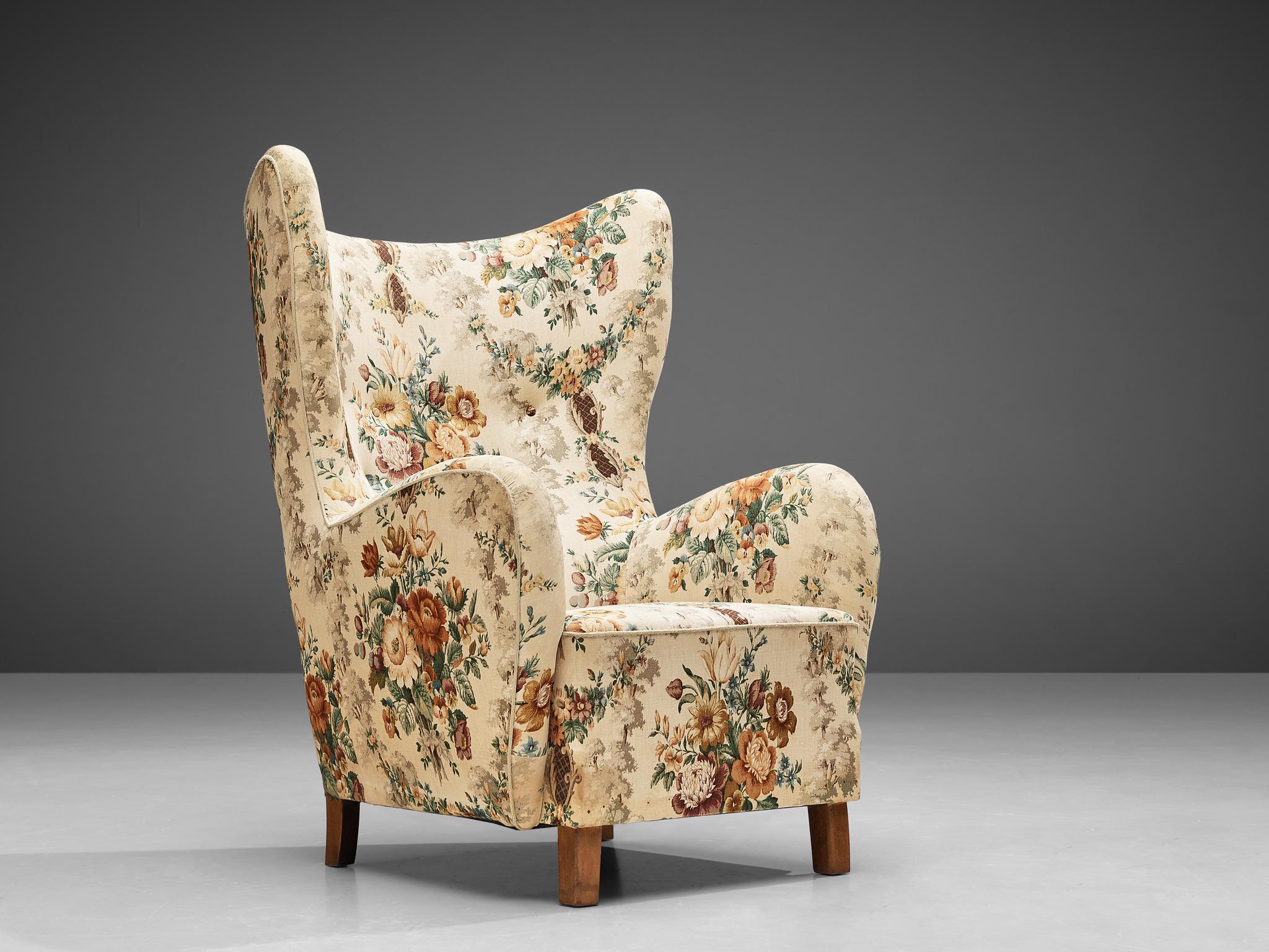 Fritz Hansen, armchair, fabric, oak, Denmark, 1950s.

This archetypical wingback chair of the 1950s is both extremely comfortable and pleasing to the eyes. Soft edges, tilted shapes and beautiful upholstery make this a truly mid-modern armchair