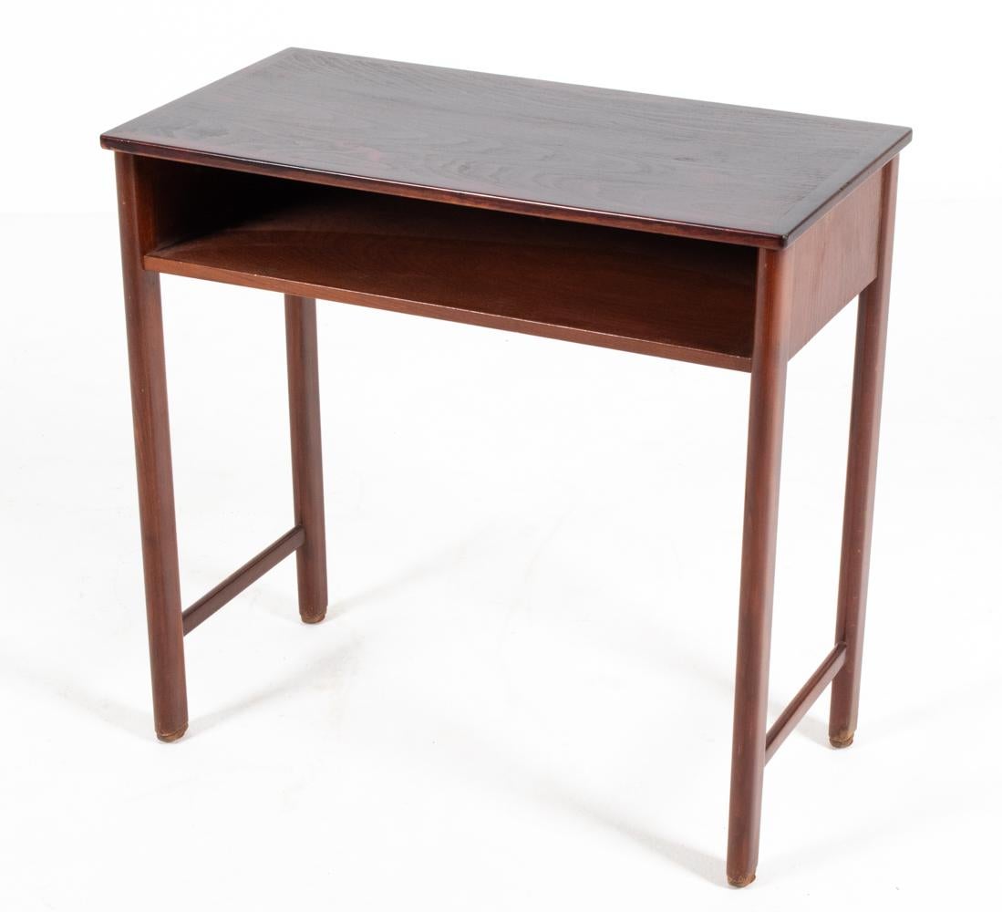 Dive into the timeless elegance of mid-century Danish design with this exquisite Fritz Hansen Model 1669 end table. Crafted meticulously from rich mahogany, this table exemplifies the perfect marriage of form and function. Its sleek, clean lines and