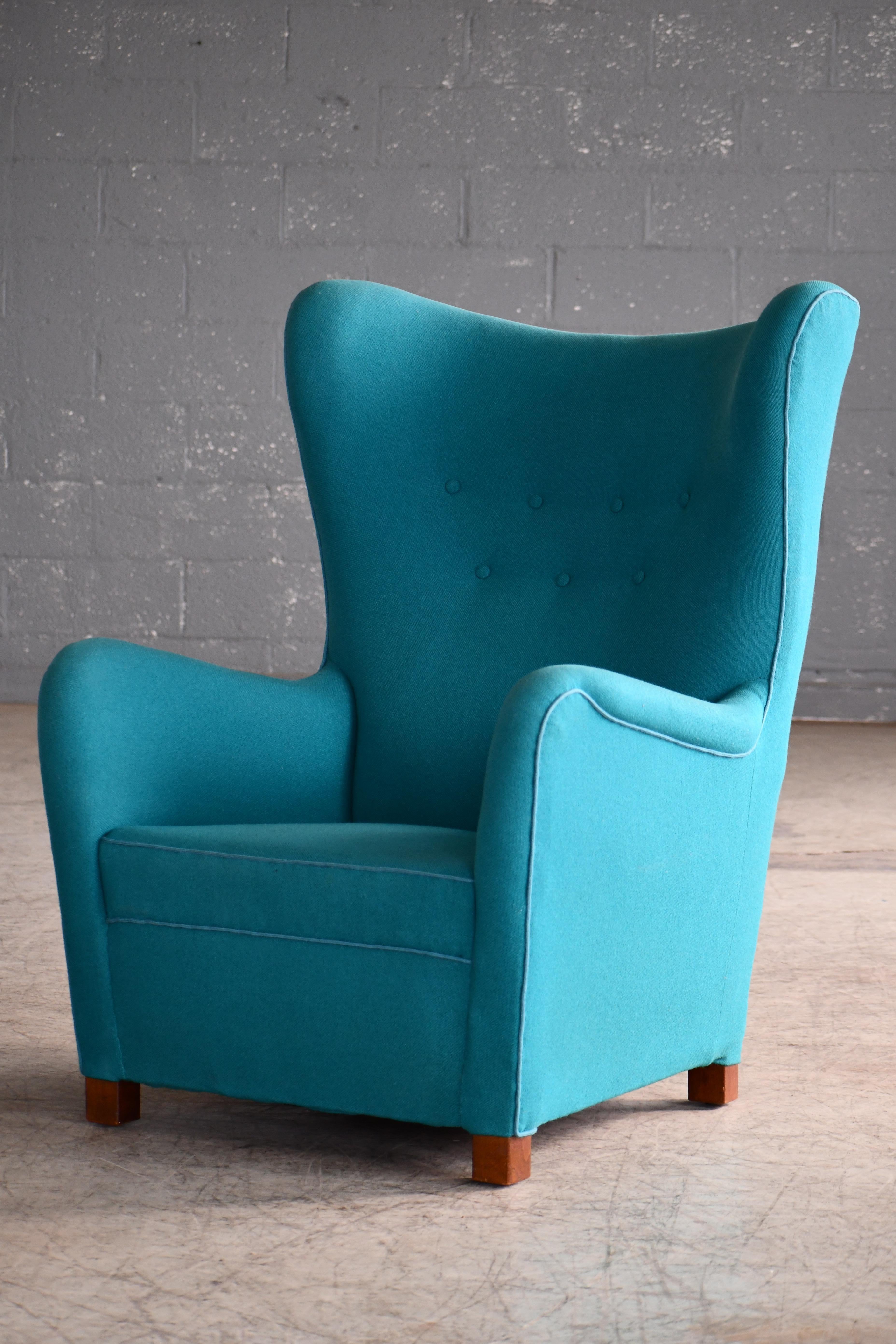 Sought after Fritz Hansen Model 1672 high back lounge chair made circa 1942. The Model 1672 chair was first seen on page 12 in Fritz Hansen's 1942 catalog. The chair has since become of the most sought after and iconic high back chairs to come out