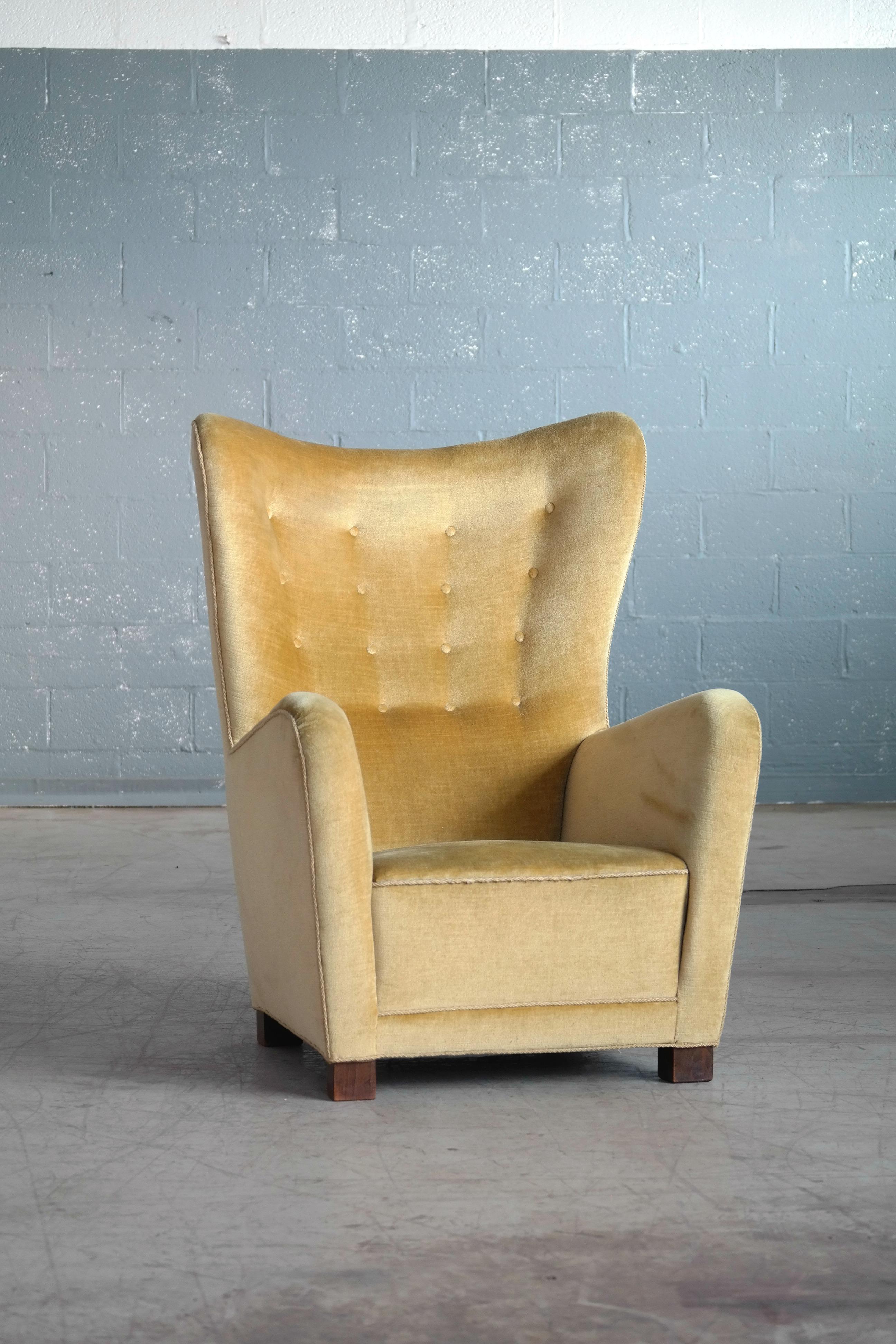 Sought after Fritz Hansen Model 1672 high back lounge chair made circa 1942. The chairs was first seen on page 12 in Fritz Hansen's 1942 catalog. The model 1672 has become of the most sought after and iconic high back chairs to come out of the