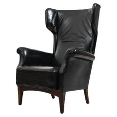 Retro Fritz Hansen, model 8023 wingback lounge chair. Original patinated black leather