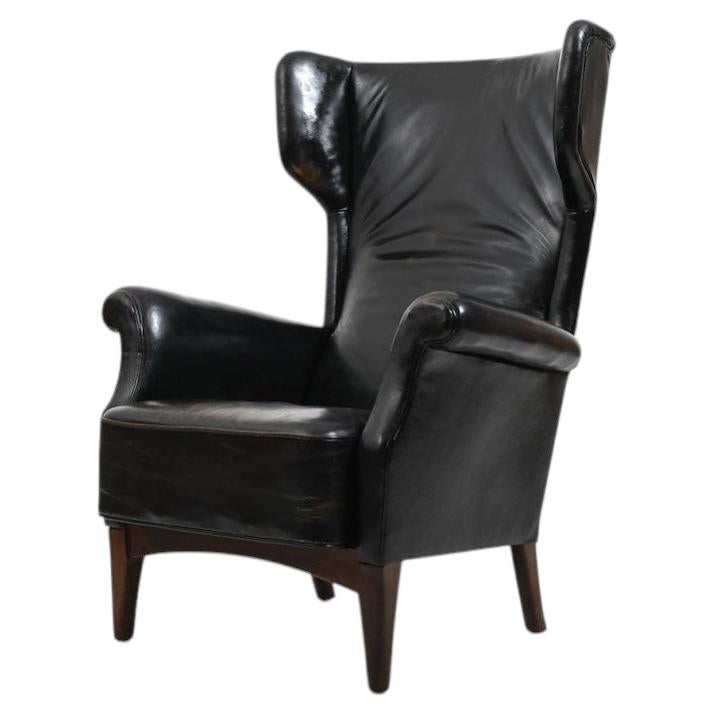 Fritz Hansen, model 8023 wingback lounge chair. Original patinated black leather For Sale