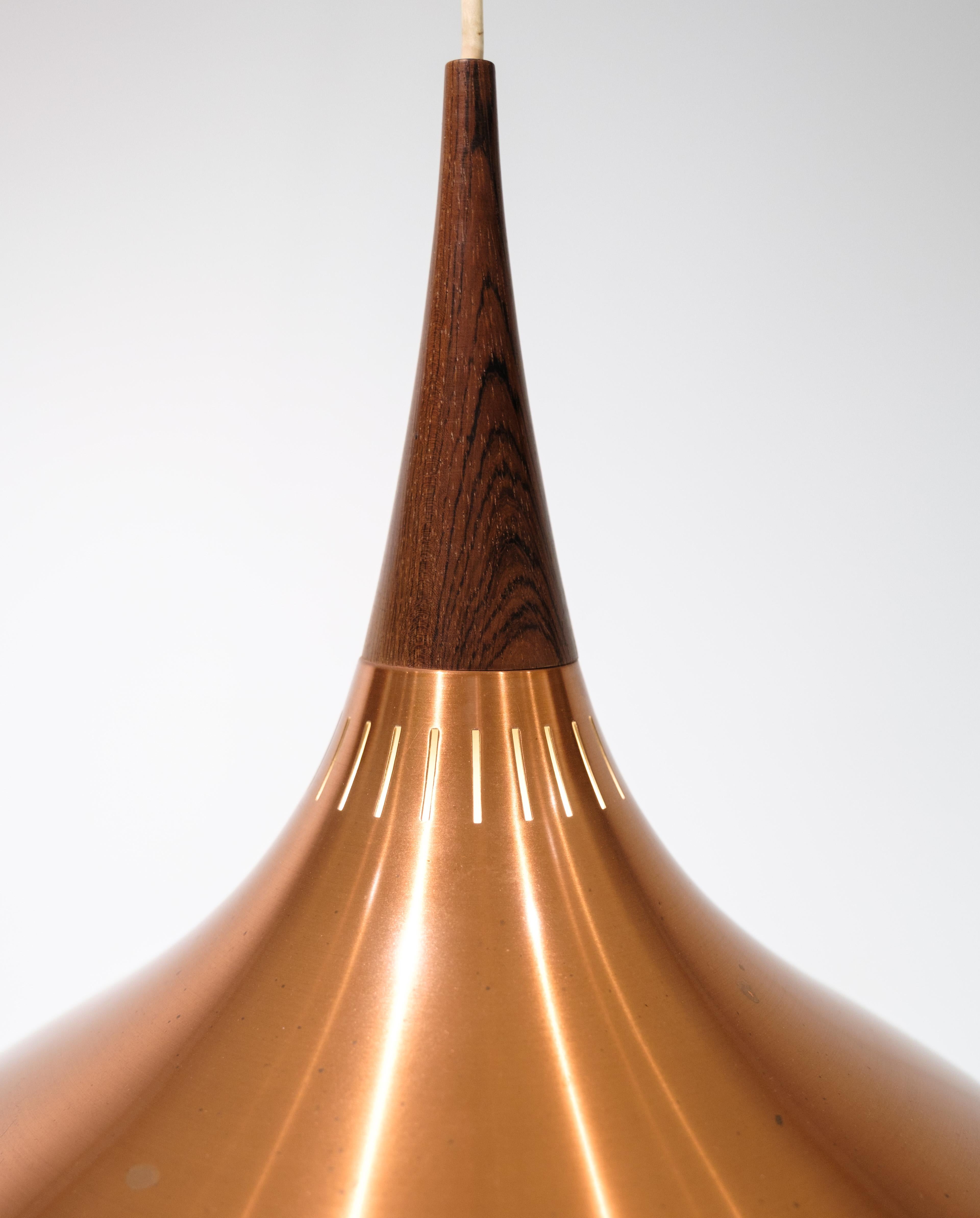 Early model of the Fritz Hansen Orient P1 pendant in copper and rosewood, designed by Jo Hammerborg from around the 1960s.
H: 35 Dia: 33