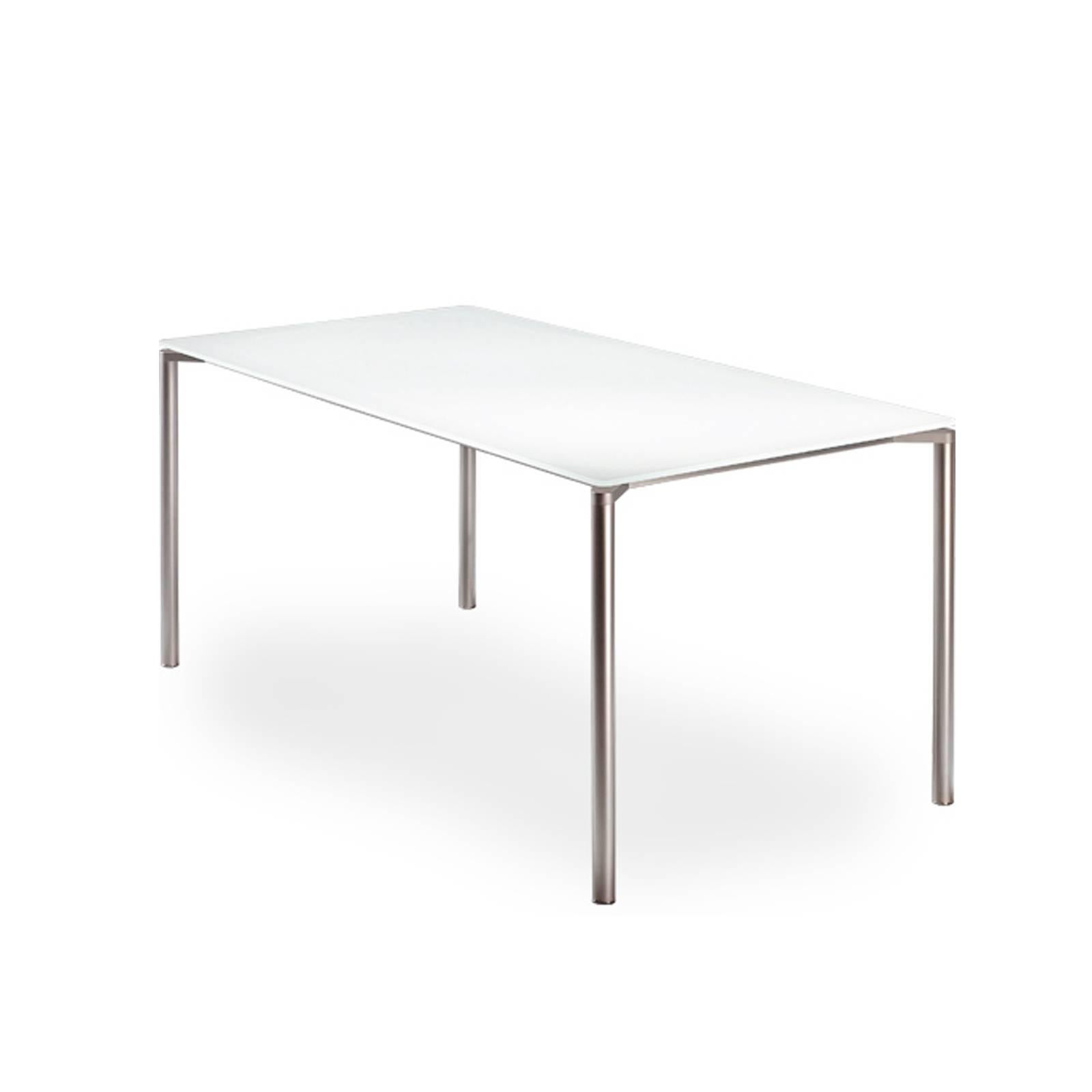 Stunning glass table by the Fritz Hansen designed by Pelikan design composed by a under-lacquered glass supported by cylindrical legs finished in a mirrored charmed steel.
The glass top sits just millimetres from the tops of the legs giving an