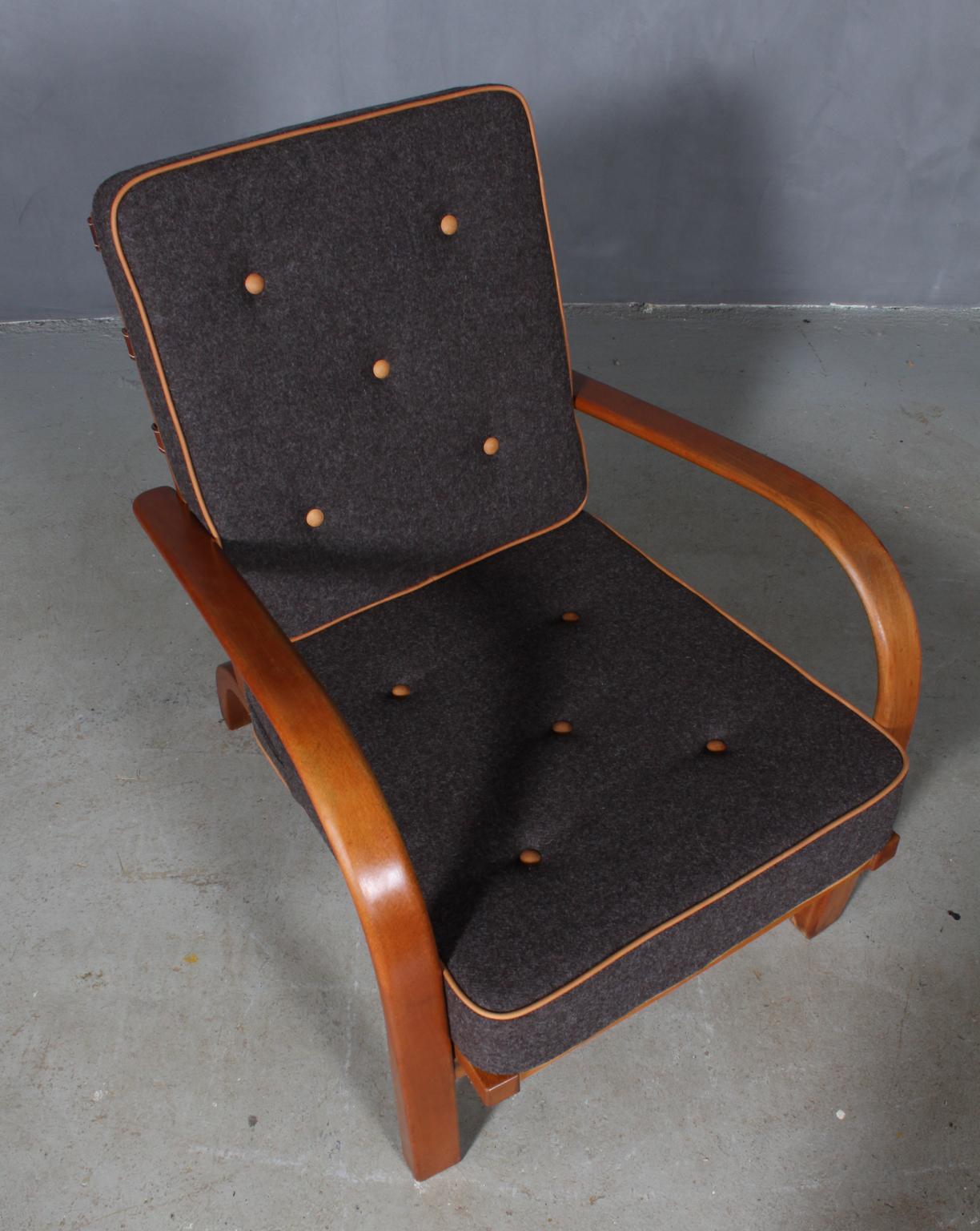 Fritz Hansen lounge chair with frame of beech.

New upholstered with 100 % New Zealand Divina wool and vintage aniline leather.

Original leather straps in the back.

Made by Fritz Hansen in the 1930s.