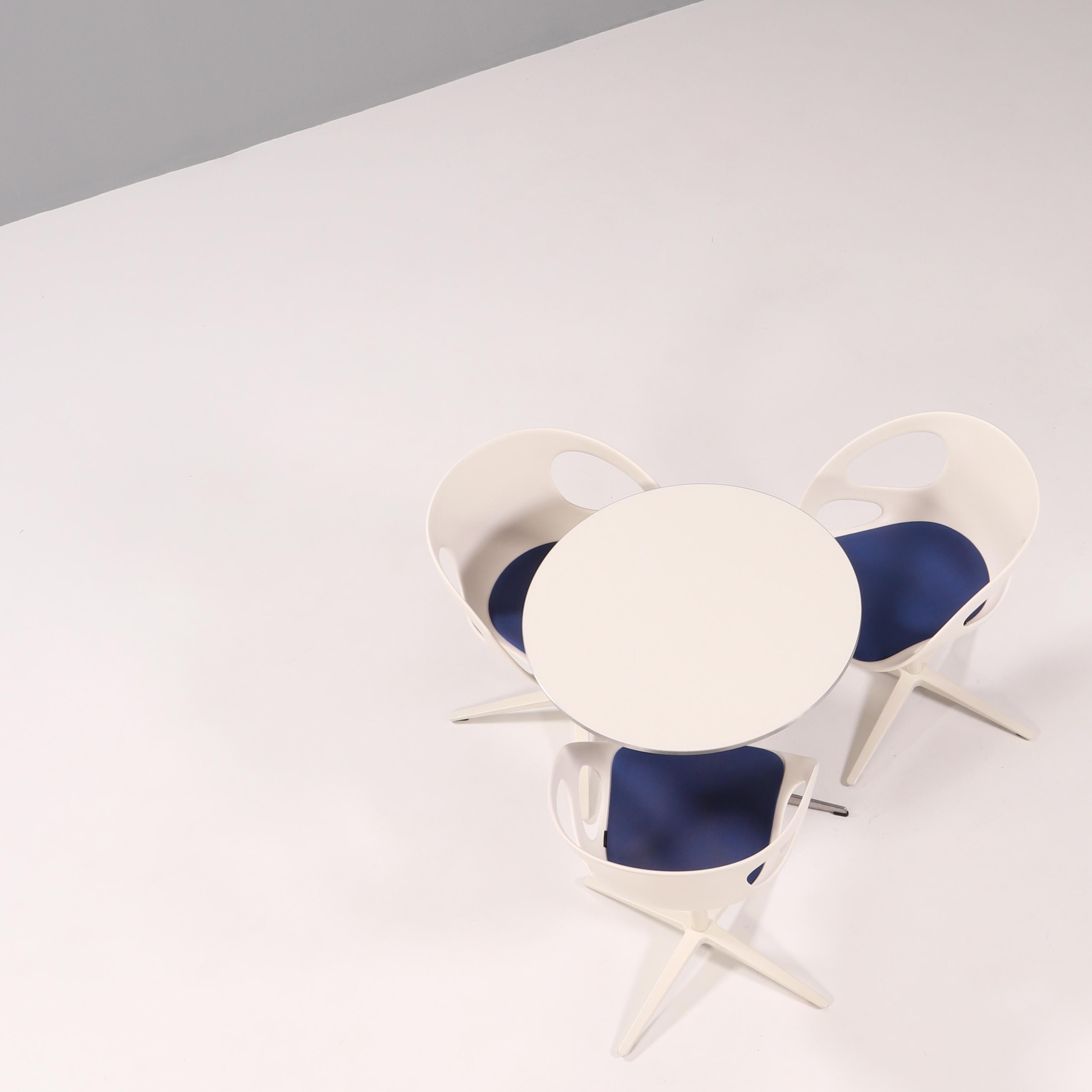 Table: 

Originally designed in 1968 by Piet Hein, Bruno Mathsson and Arne Jacobsen, the A622 table is manufactured by Fritz Hansen in Denmark.

The modern contemporary round table features a circular white laminate top with an aluminium edge,