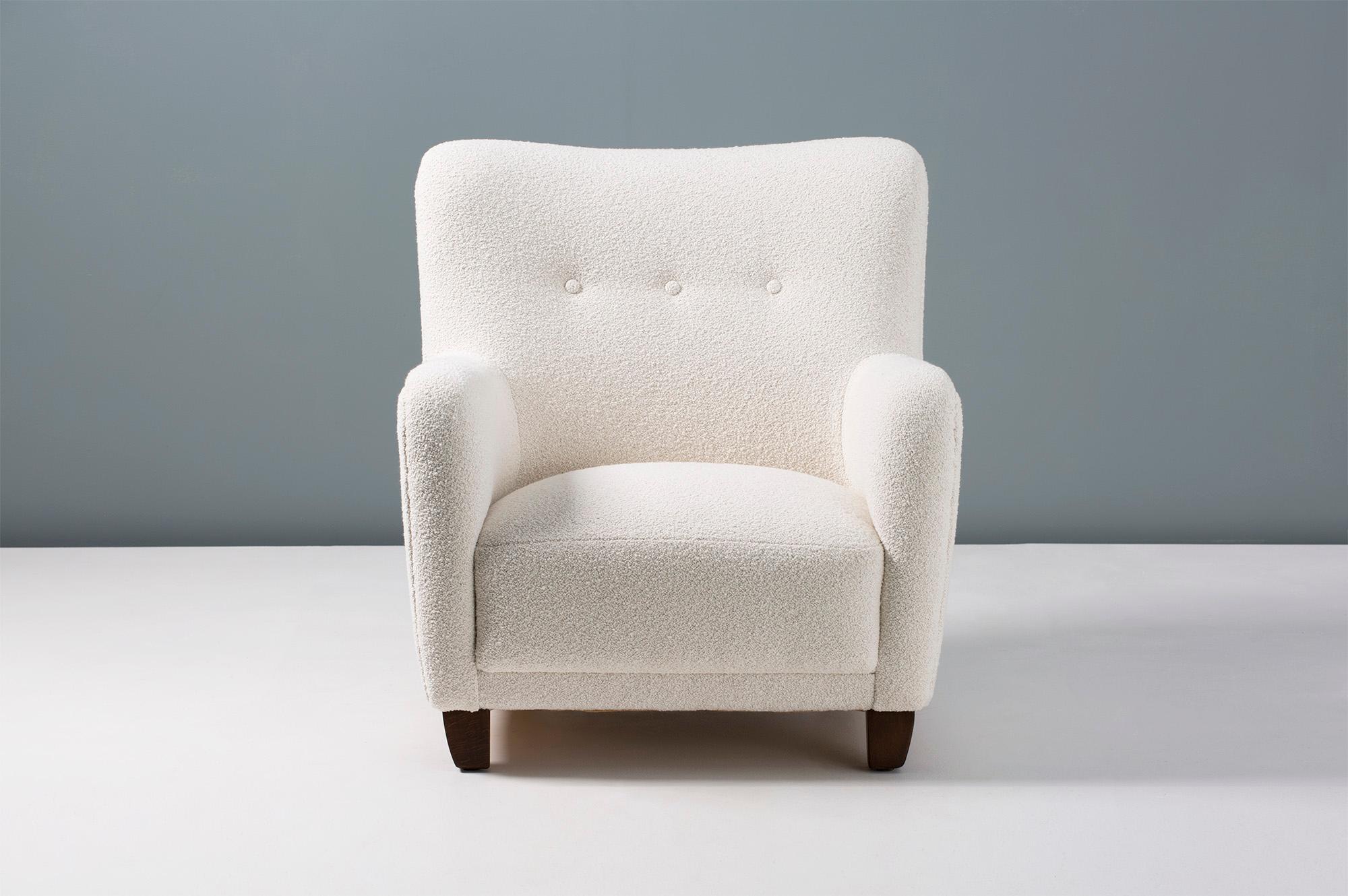 1940s vintage armchair in the manner of Fritz Hansen, produced in Denmark by FDB Mobler. The legs are stained beechwood and the chair has been reupholstered in luxurious bouclé fabric composed of cotton and wool.

Pair available by request.