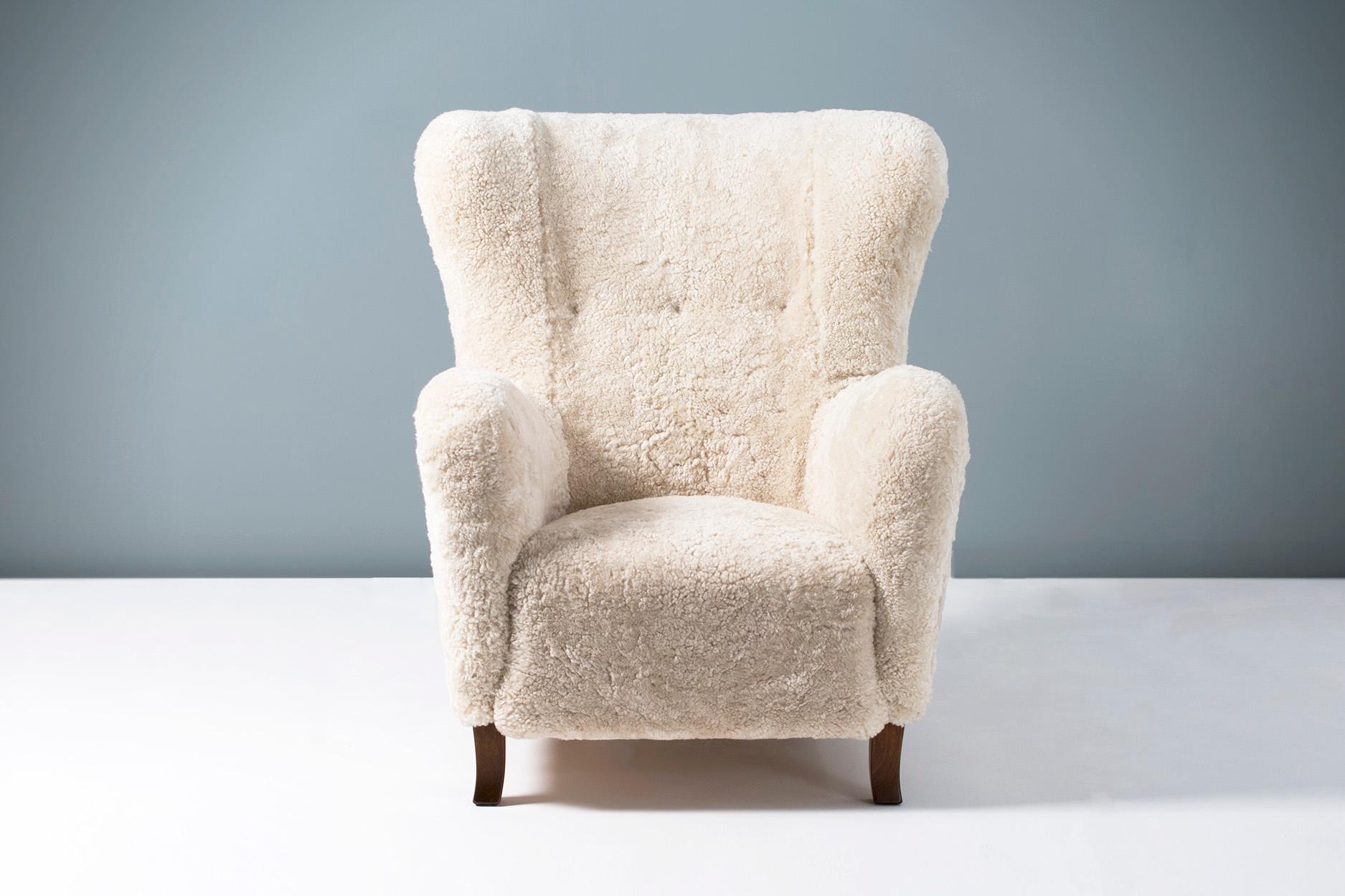 1940s vintage wing chair in the manner of Fritz Hansen, produced in Copenhagen by Christian Sorensen & Co. The legs are stained beechwood and the chair has been reupholstered in luxurious Australian shearling.


Measures: H 98cm, D 80cm, W 78cm,