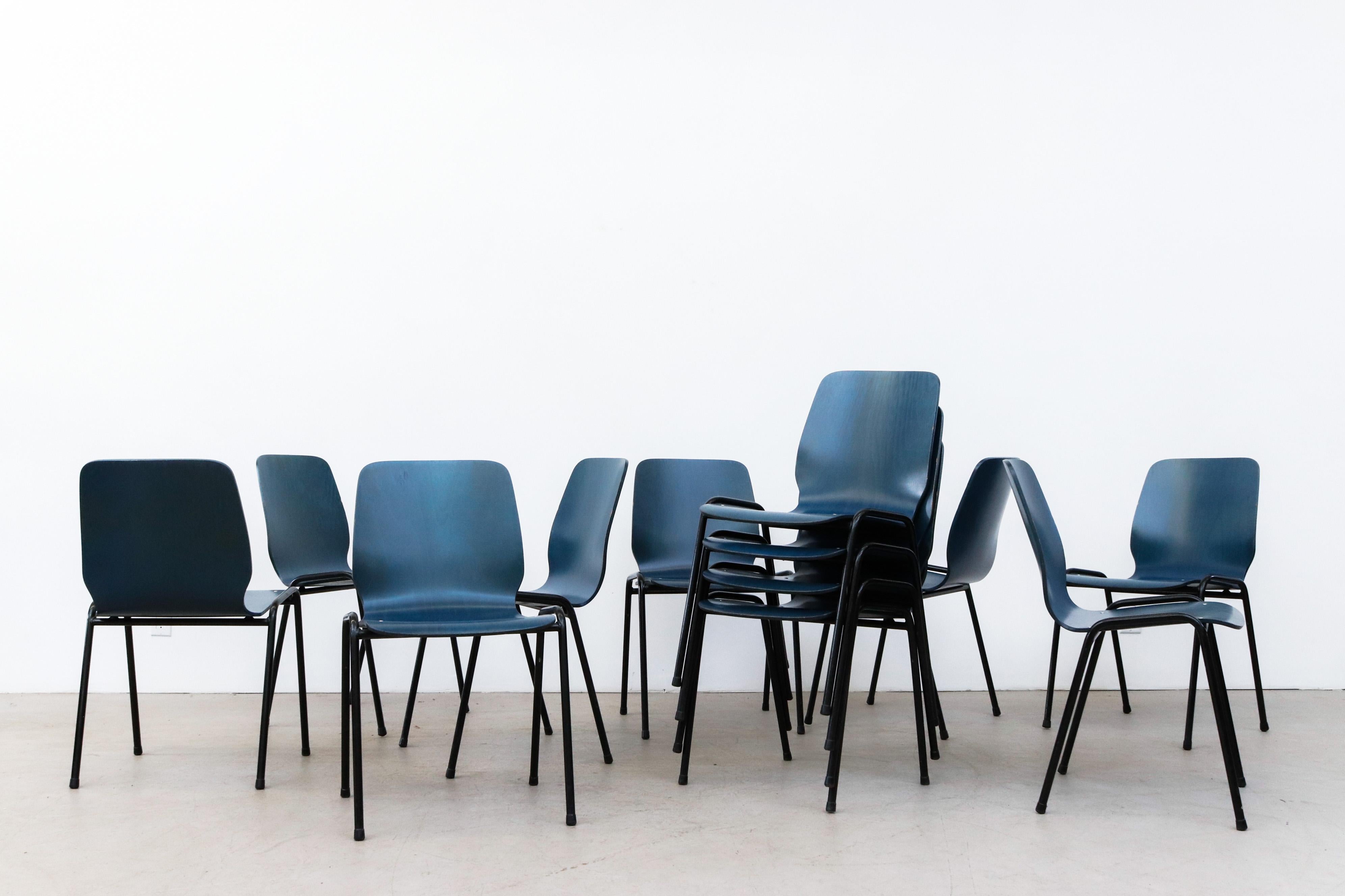 Set of 12 Fritz Hansen style blue stained bent plywood stacking chairs with black enameled tubular metal frames. In original condition withsome wear and visible chipping. Wear is consistent with their age and use. Green stained ansen Style wingback