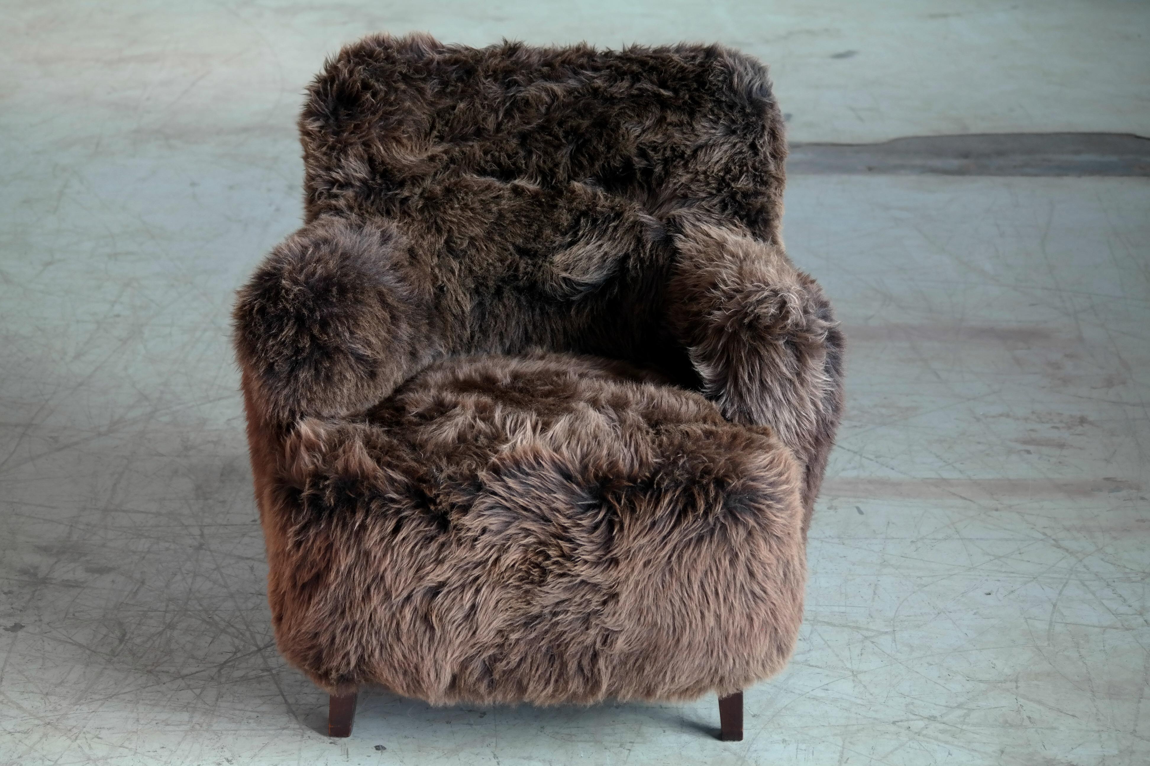 Fabulous Fritz Hansen Style Danish 1950s medium size lounge chair covered in super soft Icelandic natural sheepskin. Super comfortable and so warm and plush - perfect for the Lady of the Manor's bedroom or dressing room. Newly upholstered excellent