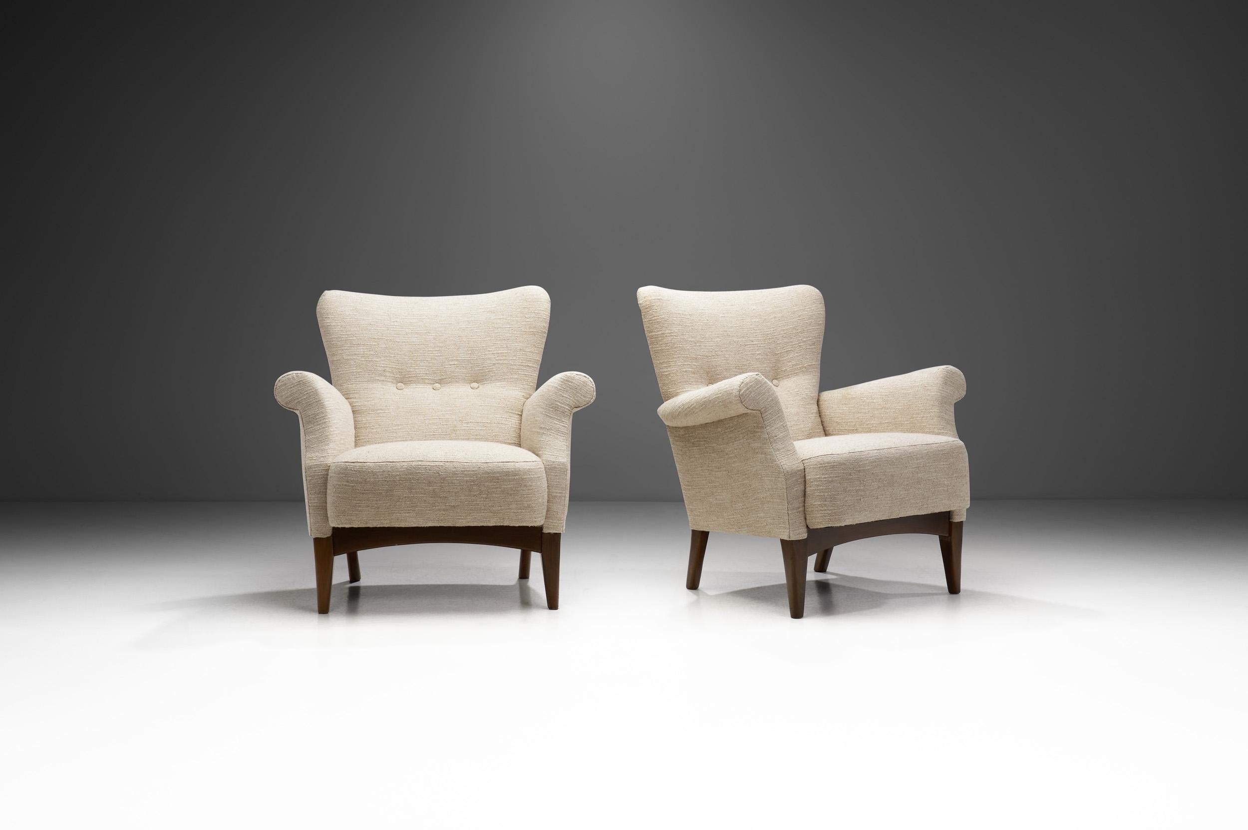 Throughout Scandinavia, there's a long history of pride in craftsmanship which is especially true of Denmark and one of its most reputable furniture makers, Fritz Hansen. This beautiful pair of armchairs is an exceptional flagbearer of Danish
