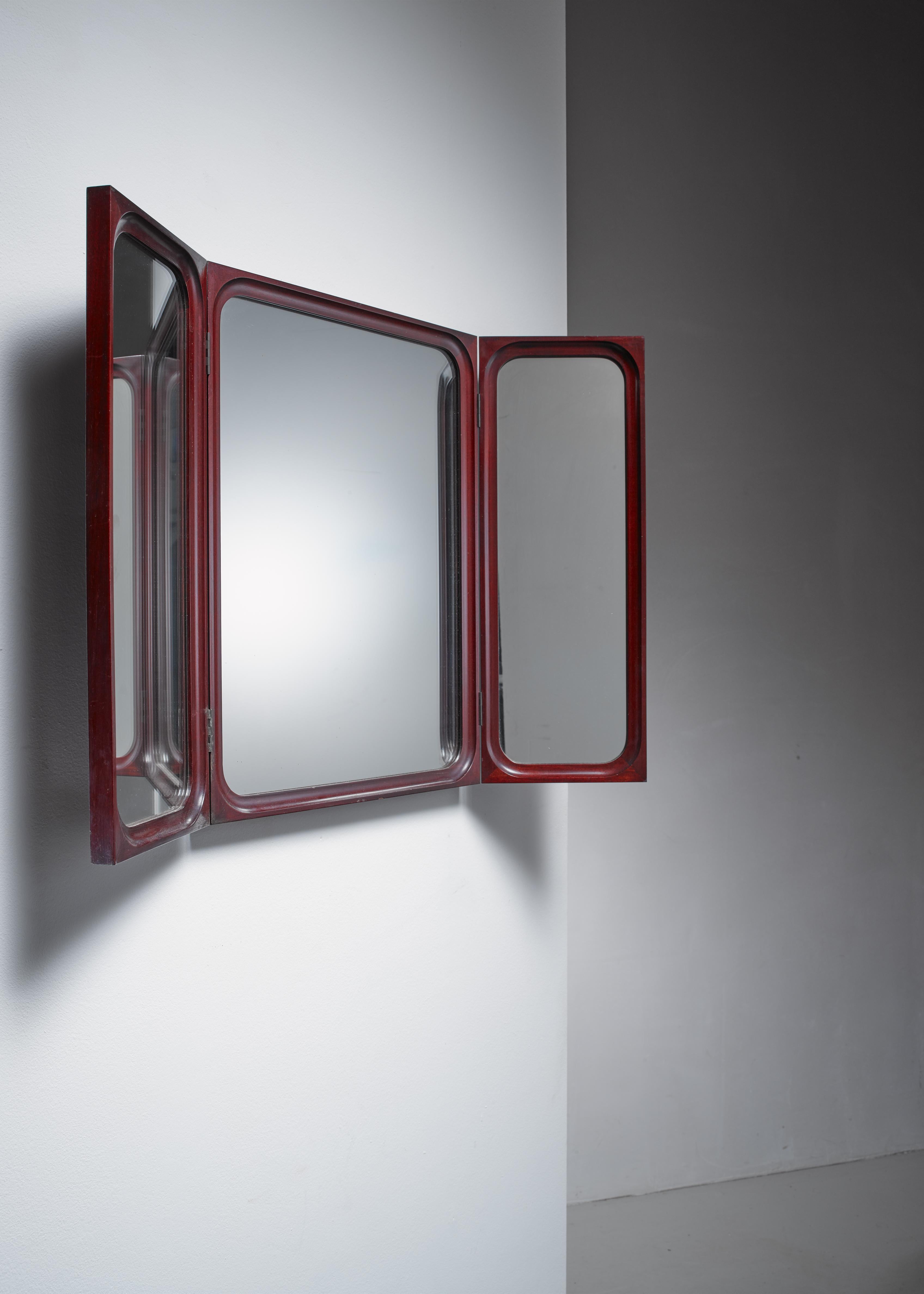 A folding, triptych wall mirror in mahogany by Frode Holm for Illums Bolighus.

When folded out the mirror is 89.5 cm wide.
 