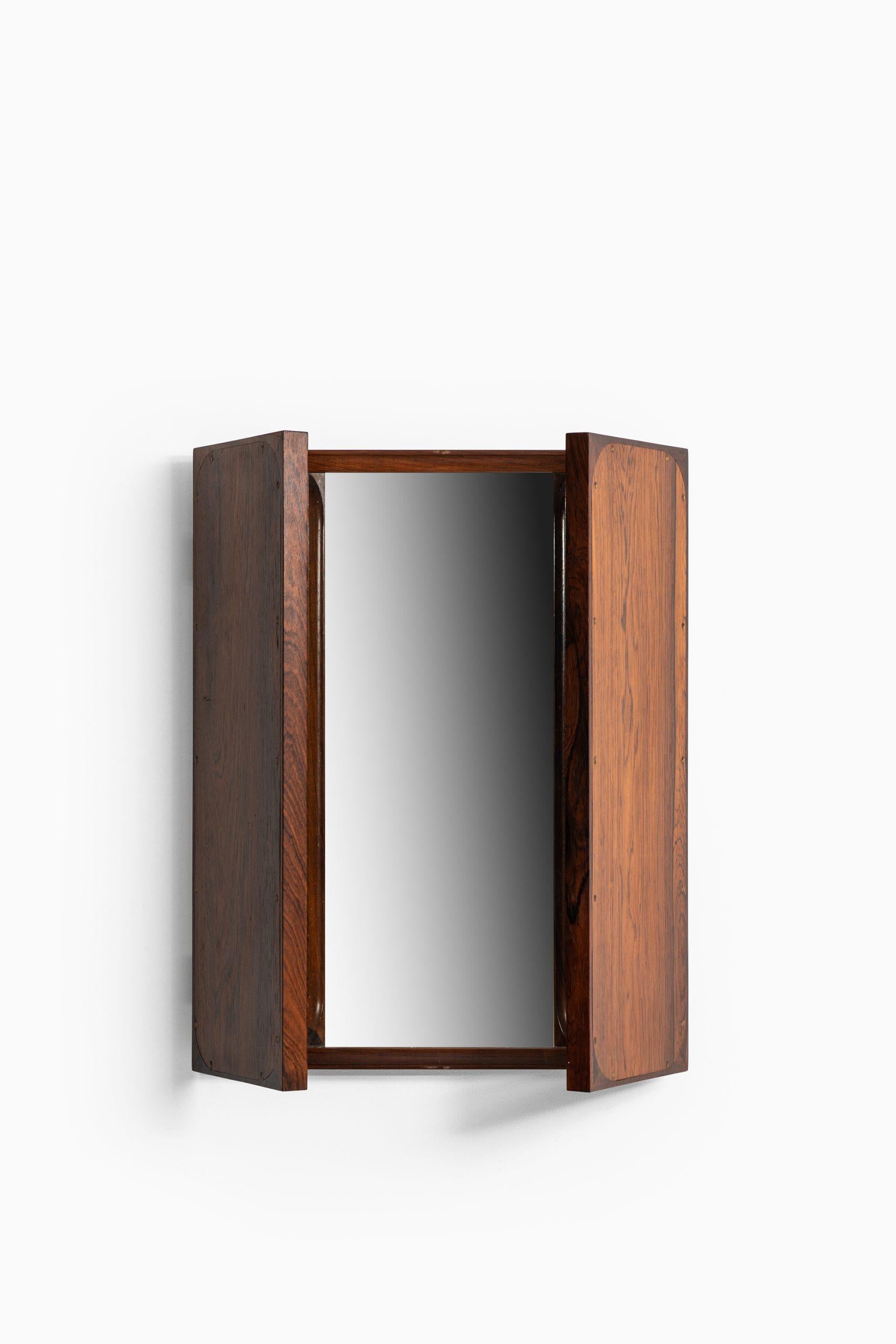 Rare folding mirror designed by Frode Holm. Produced by Illums Bolighus in Denmark.
Measures: Width 43-86 cm.