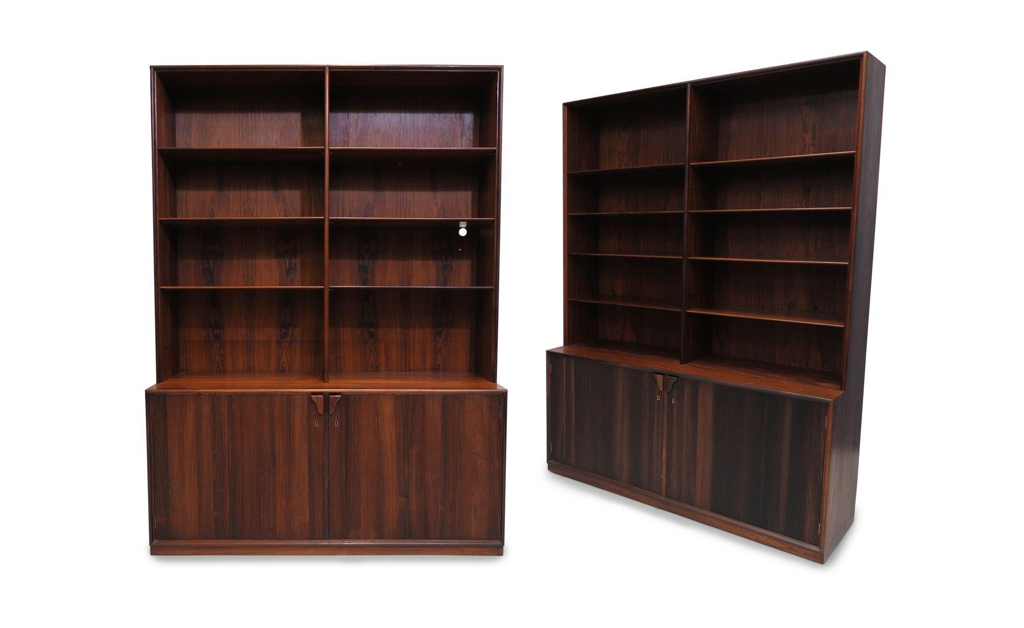 Pair of elegant midcentury cabinets designed by Frode Holm for Illums Bolighus, 1955, Denmark. The cabinets are crafted of the finest Brazilian rosewood and exhibit fine joinery throughout with routed edges, tapered shelves and full panel sides The