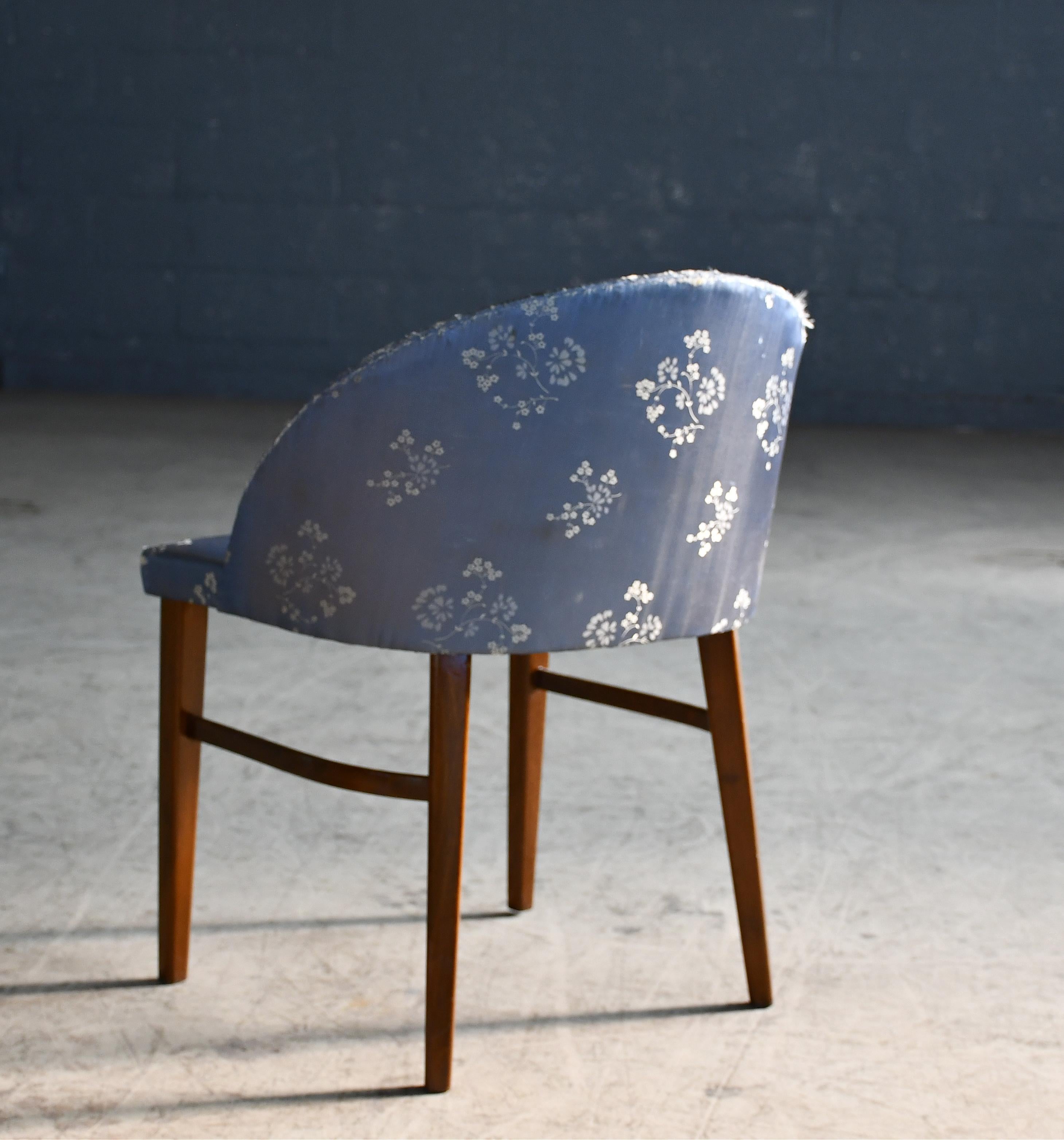 Rare variant of Frode Holms well-knows vanity chair. This version has a closed back and square cut legs made of mahogany. Super stylish chair perfect for the lady of the manor.  Overall very good condition with some fading to the fabric and minor
